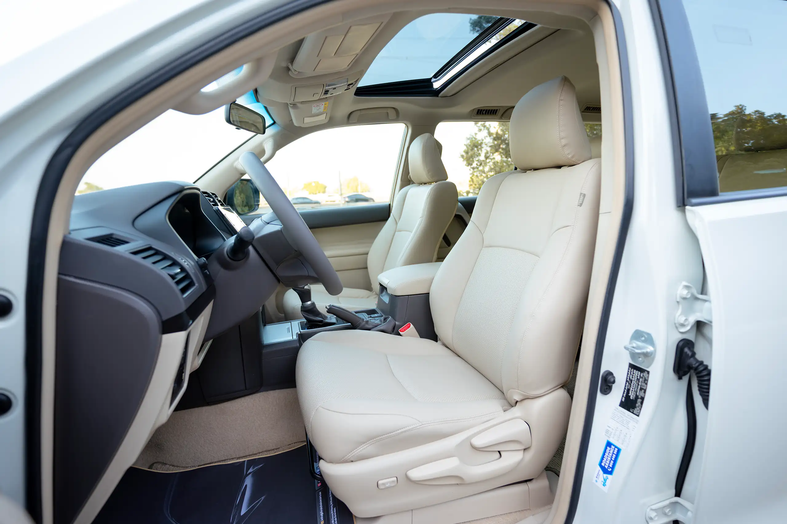 Used 2022 Toyota Prado Gxr White – Front Driver Side Cabin View at First Choice Cars Sharjah