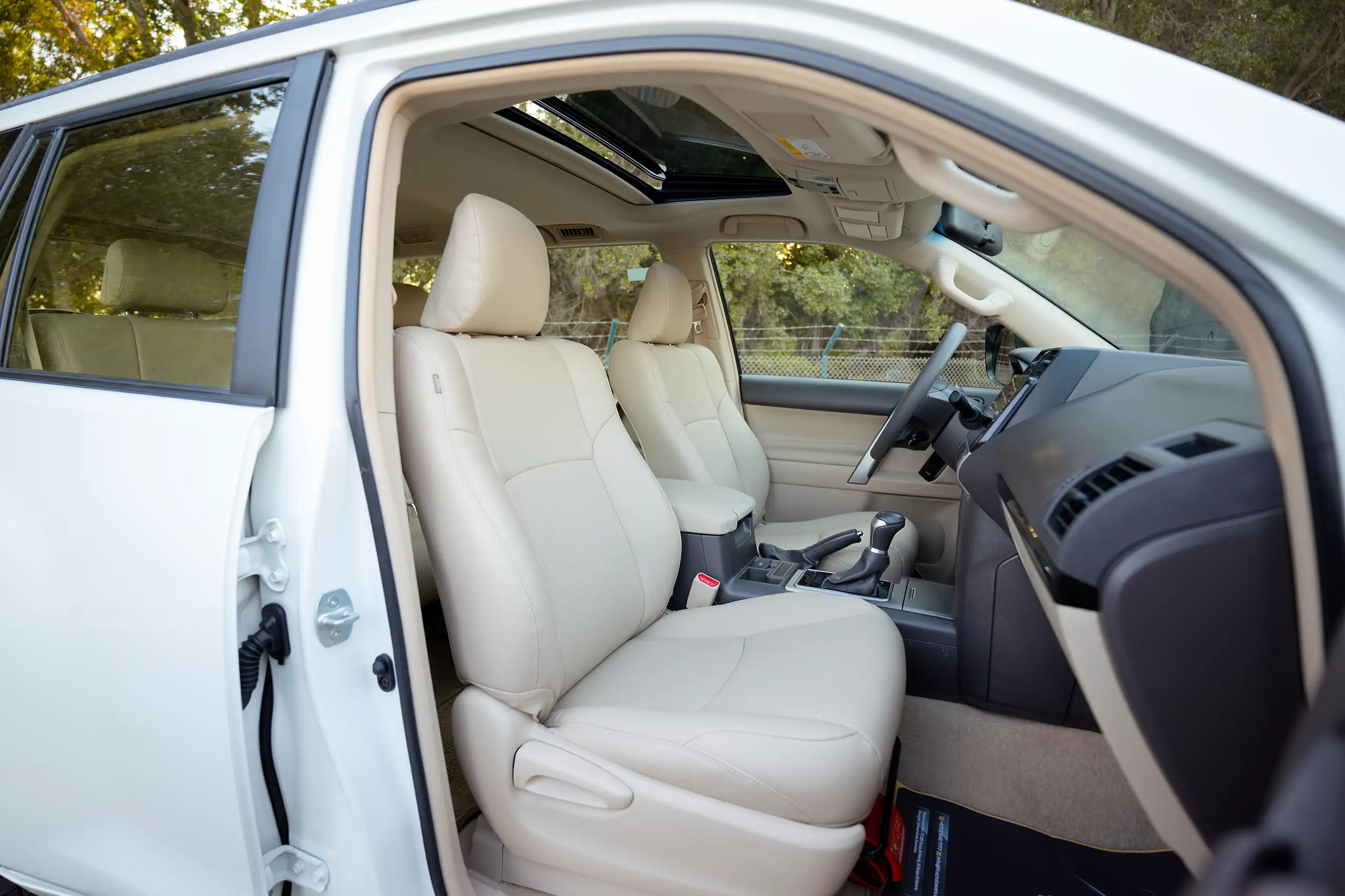 Used 2022 Toyota Prado Gxr White – Front Passenger Side Cabin View at First Choice Cars Sharjah