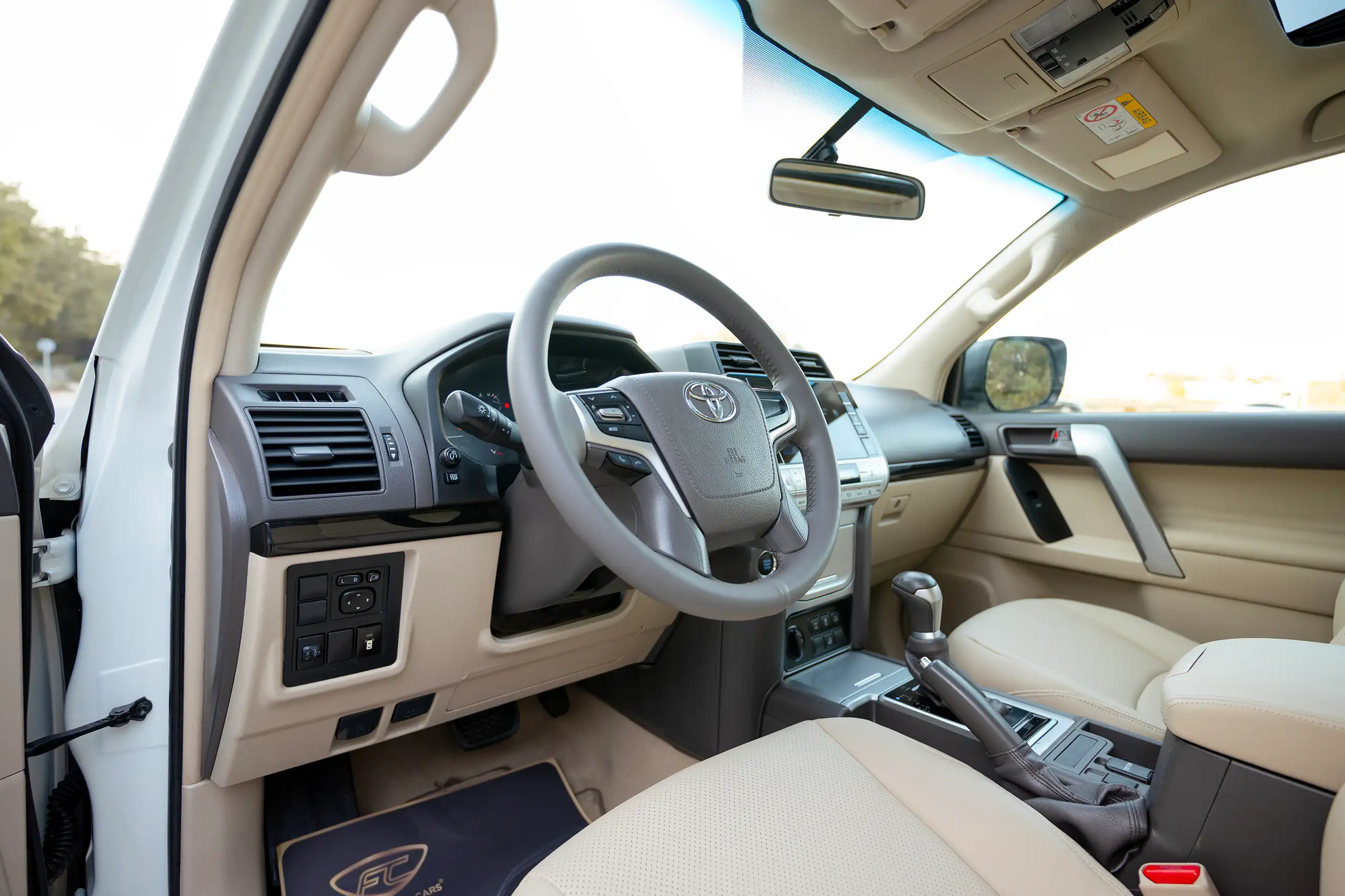 Used 2022 Toyota Prado Gxr White – Driver Side Dashboard & Steering View at First Choice Cars Sharjah