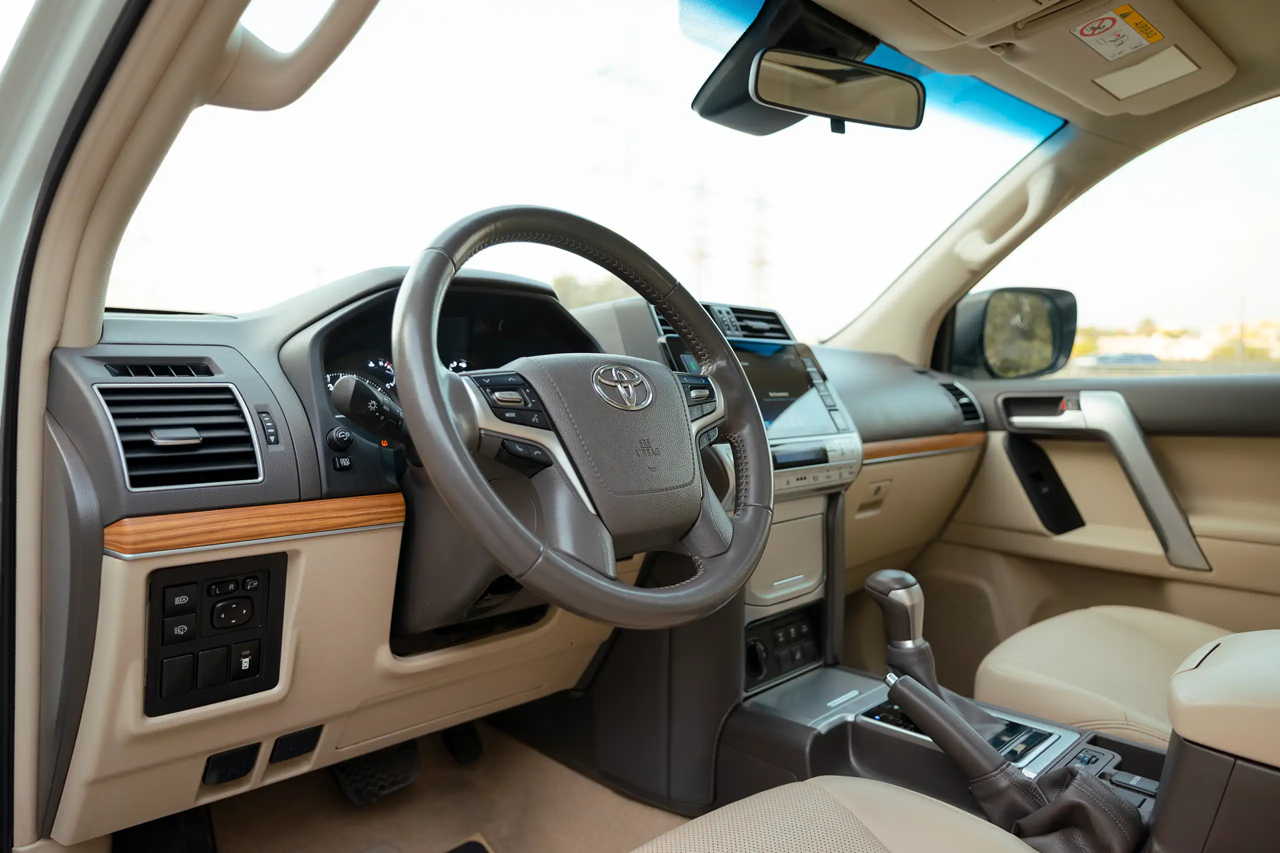 Used 2022 Toyota Prado VXR White – Driver Side Dashboard & Steering View at First Choice Cars Sharjah