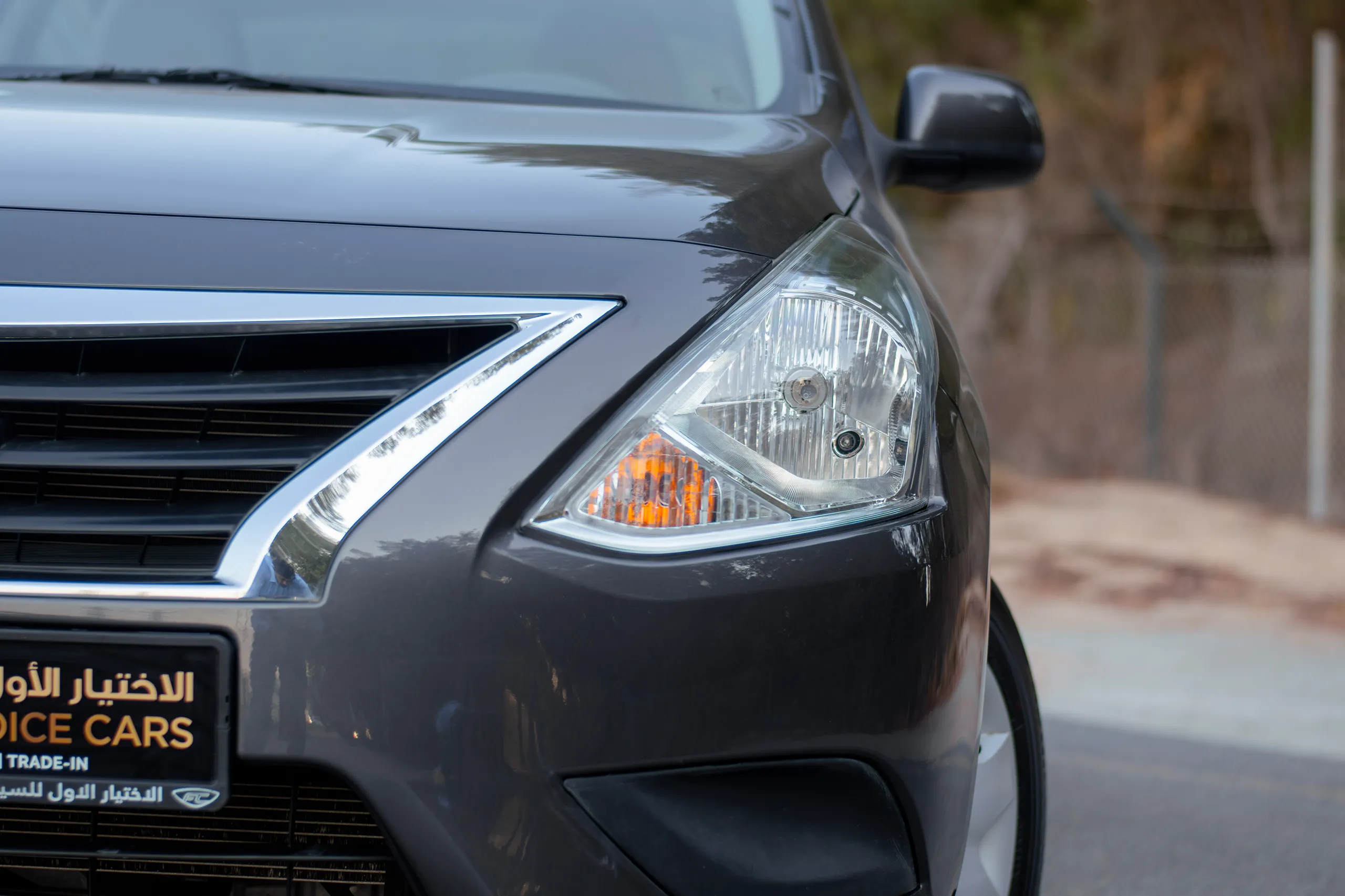 Used 2023 Nissan Sunny SV Grey – Headlight Close-up at First Choice Cars Sharjah