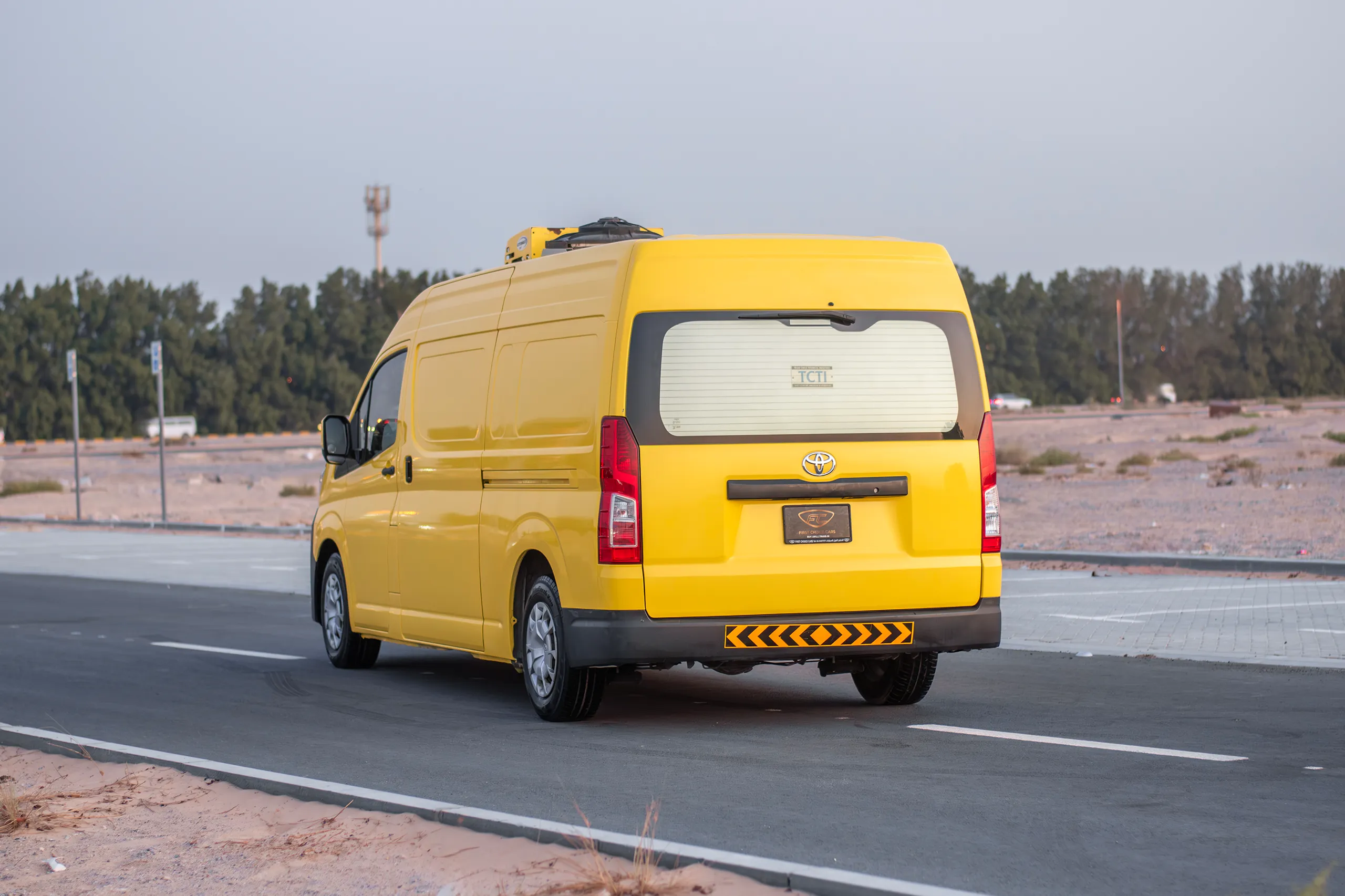 Used 2020 Toyota Hiace GL- High Roof Yellow – Left Back Diagonal (45°) View at First Choice Cars Sharjah