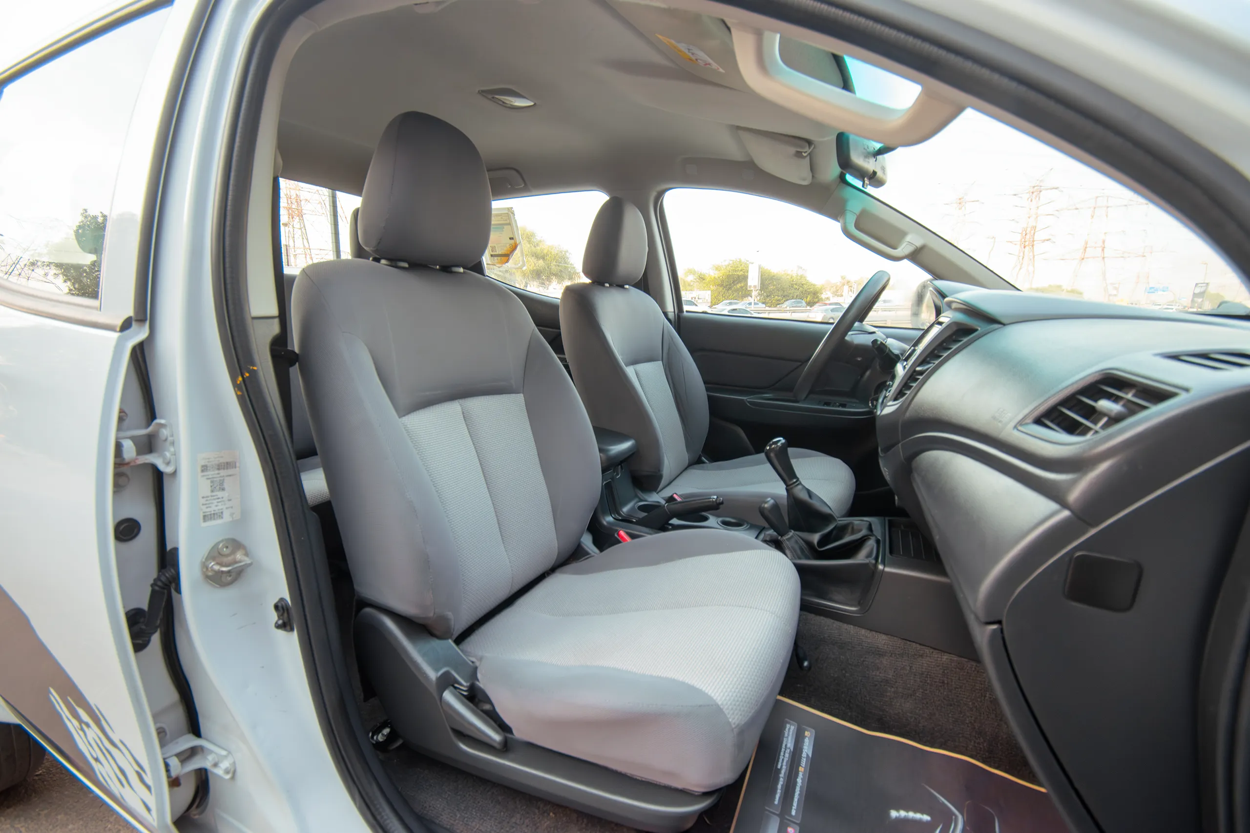 Used 2020 Mitsubishi L200 Double Cab GLX White – Front Passenger Side Cabin View at First Choice Cars Sharjah