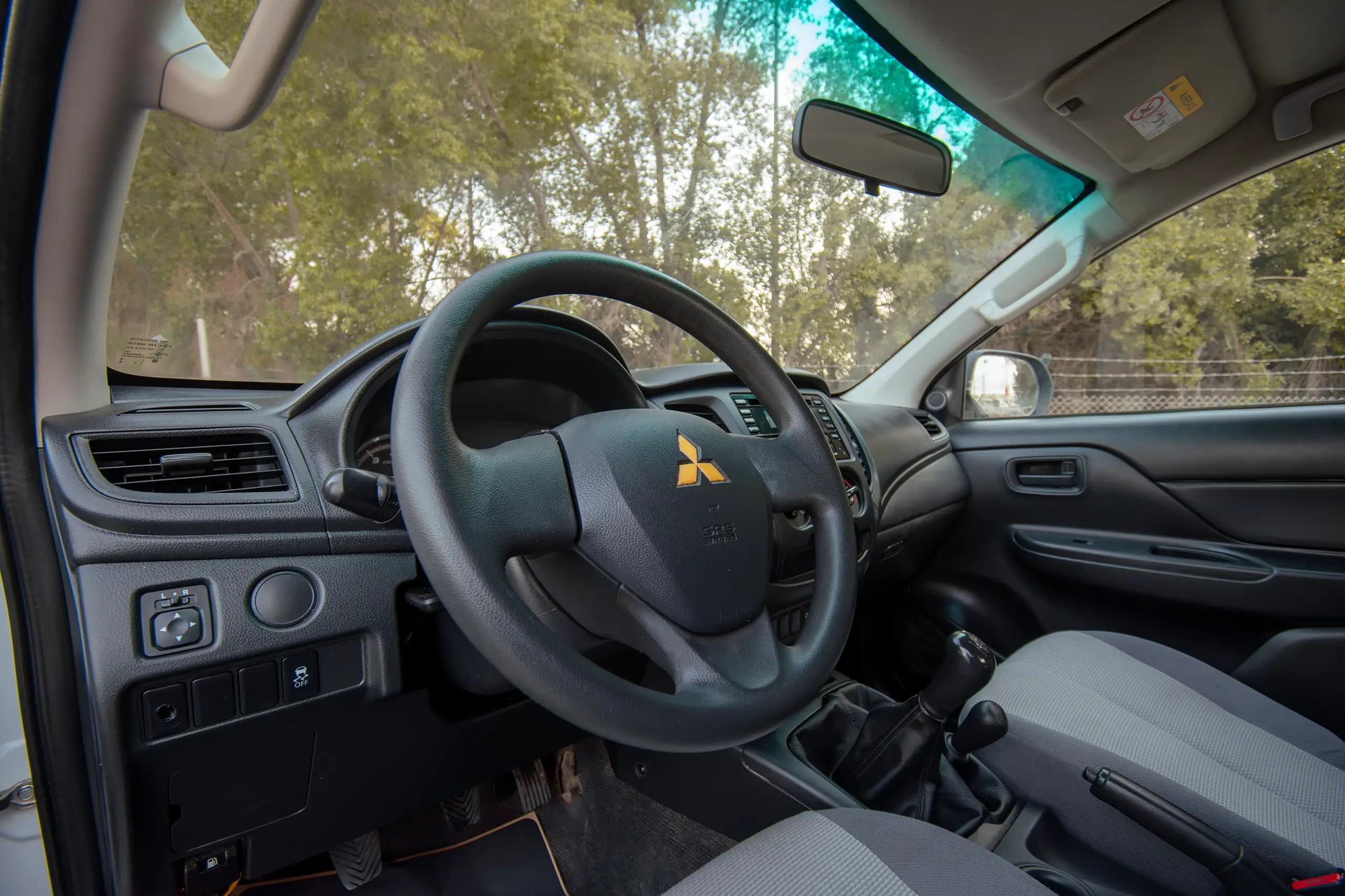 Used 2020 Mitsubishi L200 Double Cab GLX White – Driver Side Dashboard & Steering View at First Choice Cars Sharjah
