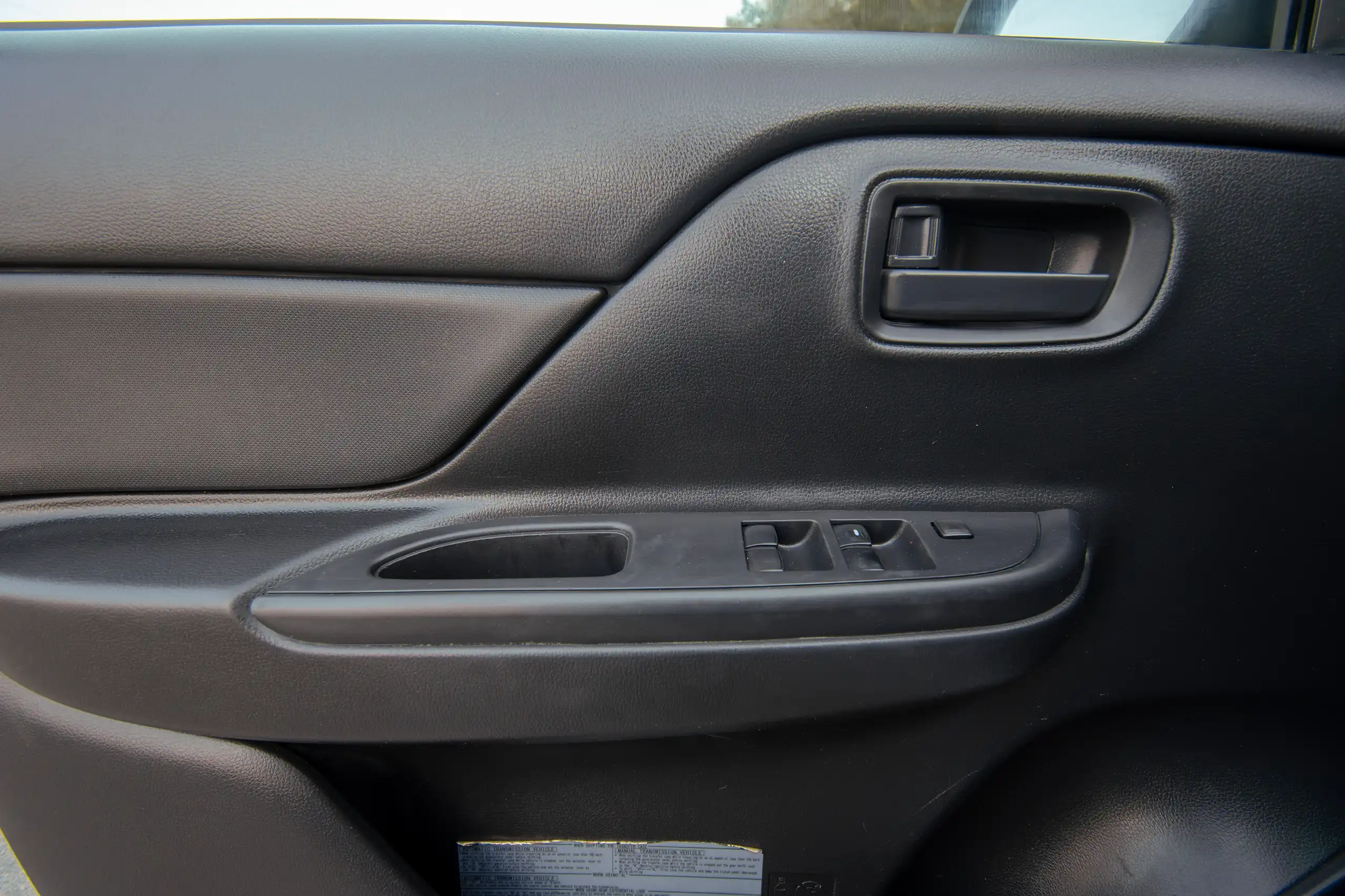 Used 2020 Mitsubishi L200 Double Cab GLX White – Driver Door Panel Full View at First Choice Cars Sharjah