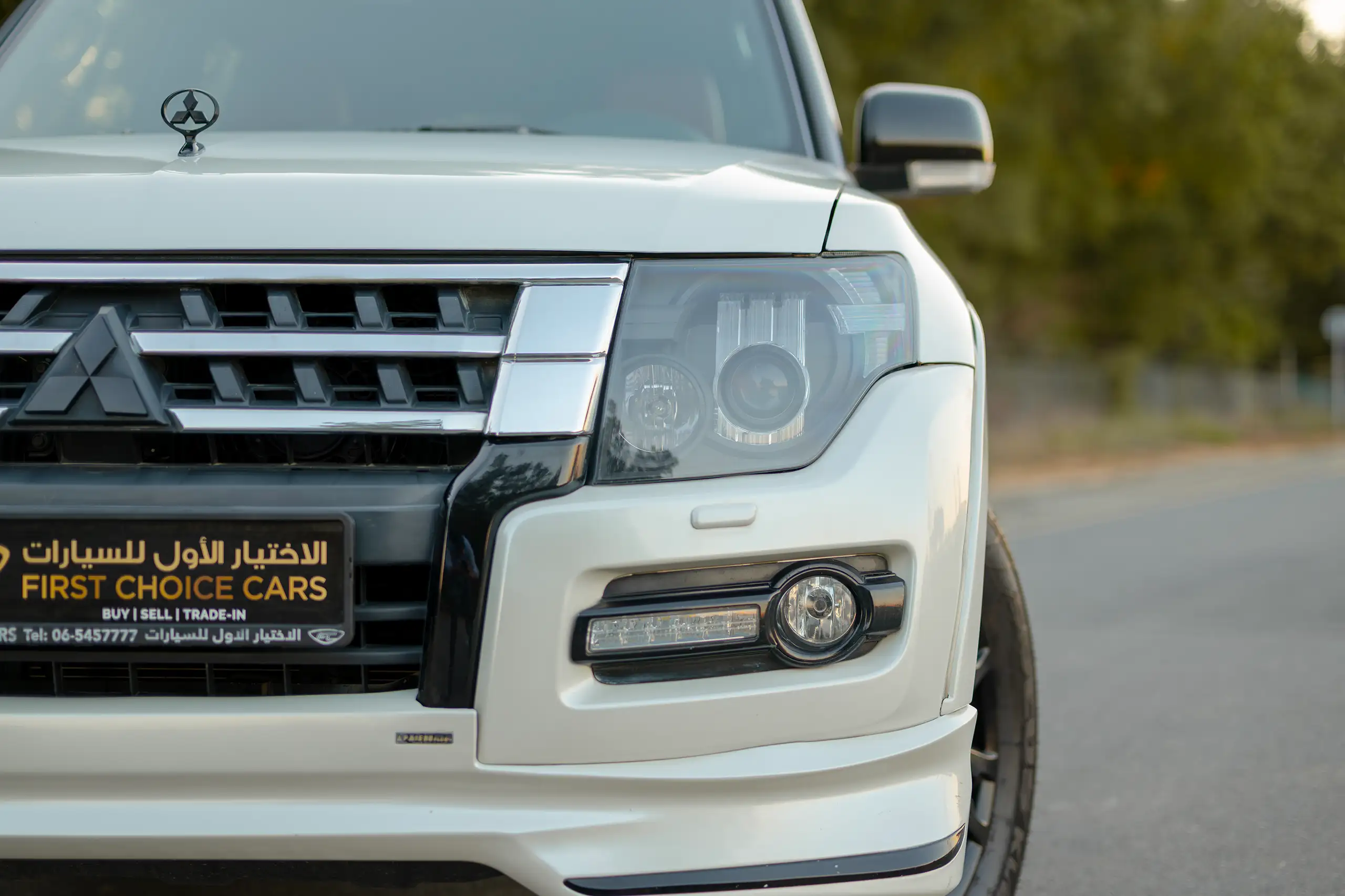 Used 2020 Mitsubishi Pajero Signature Edition White – Headlight Close-up at First Choice Cars Sharjah
