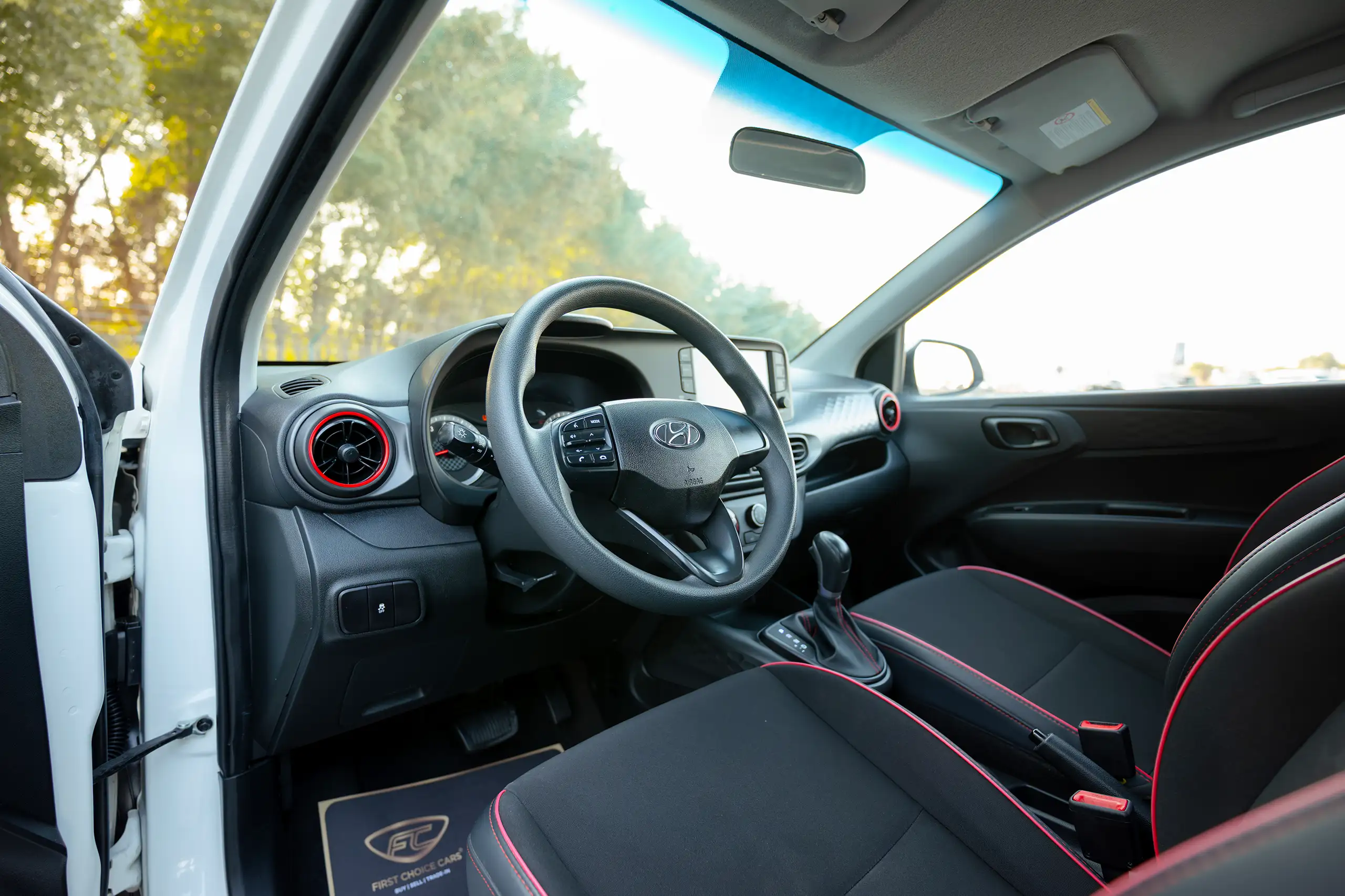 Used 2023 Hyundai Grand i10 Smart White – Driver Side Dashboard & Steering View at First Choice Cars Sharjah