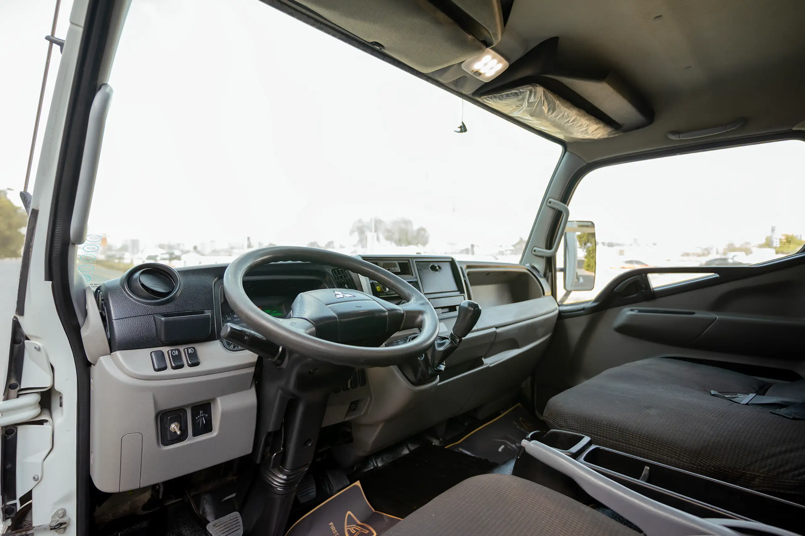 Used 2020 Mitsubishi Canter Chiller Box White – Driver Side Dashboard & Steering View at First Choice Cars Sharjah