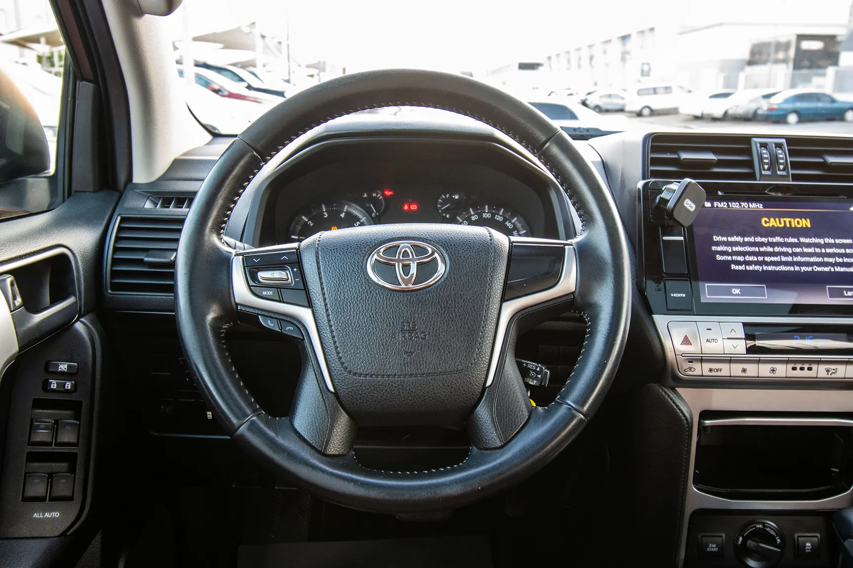 Used 2018 Toyota Prado VXR White – Driver Side Dashboard & Steering View at First Choice Cars Sharjah