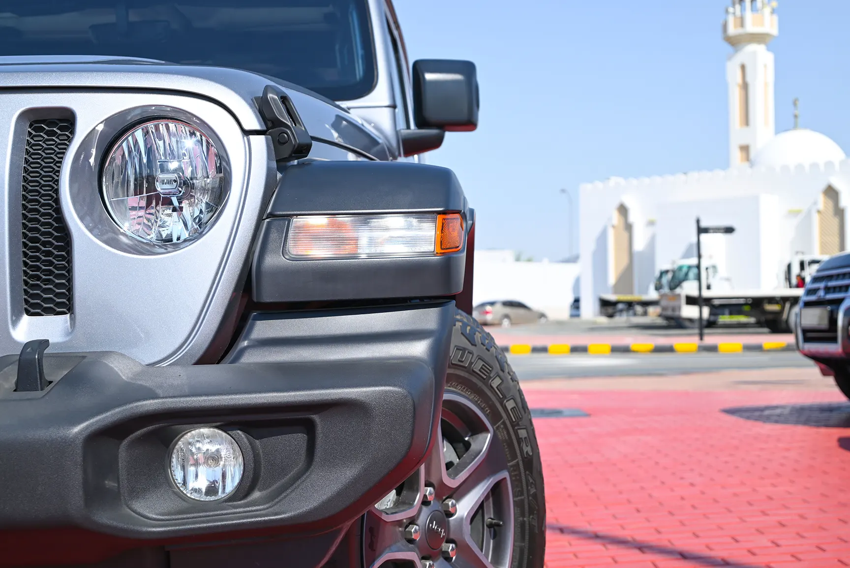Used 2019 Jeep Wrangler Unlimited Sport Silver – Headlight Close-up at First Choice Cars Sharjah