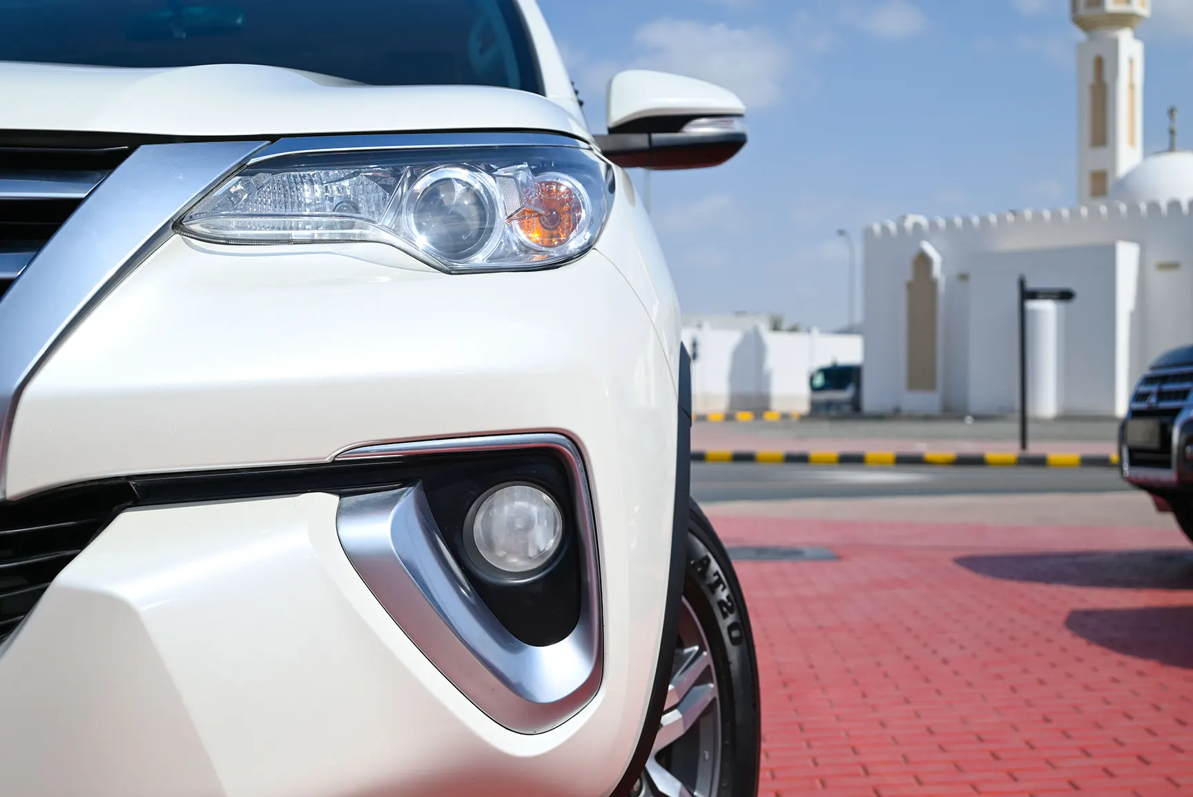 Used 2017 Toyota Fortuner GXR in White – Headlight Close-up for Sale at First Choice Cars Dubai Sharjah
