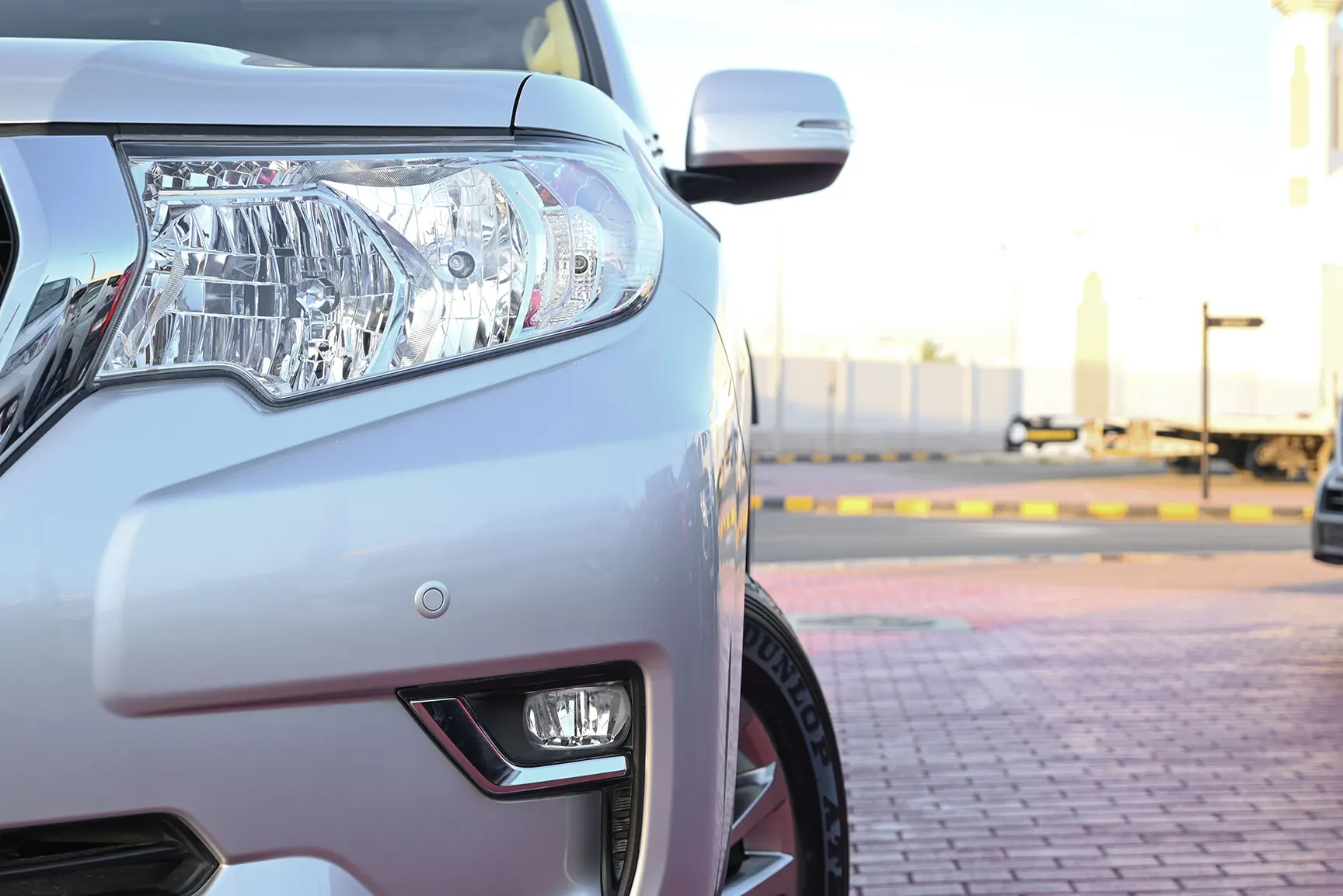 Used 2021 Toyota Prado GXR White – Headlight Close-up at First Choice Cars Sharjah