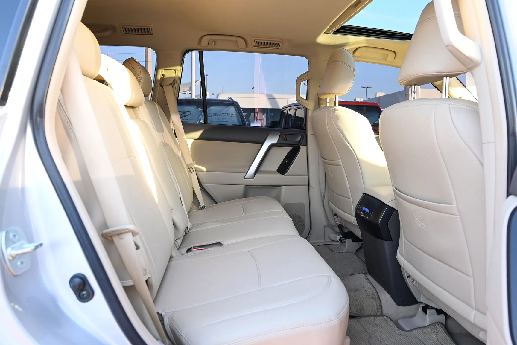 Used 2021 Toyota Prado GXR White – Rear Passenger Side Cabin View at First Choice Cars Sharjah