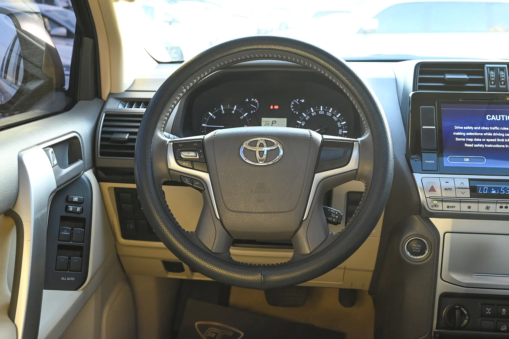 Used 2021 Toyota Prado GXR White – Driver Side Dashboard & Steering View at First Choice Cars Sharjah