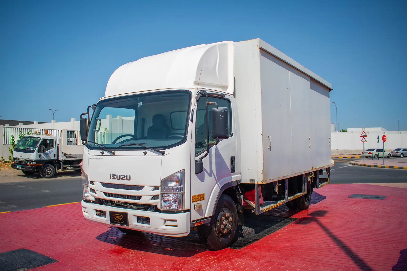 Used 2019 Isuzu NPR Cargo Box in White – Left Front Diagonal (45°) View for Sale at First Choice Cars Dubai Sharjah