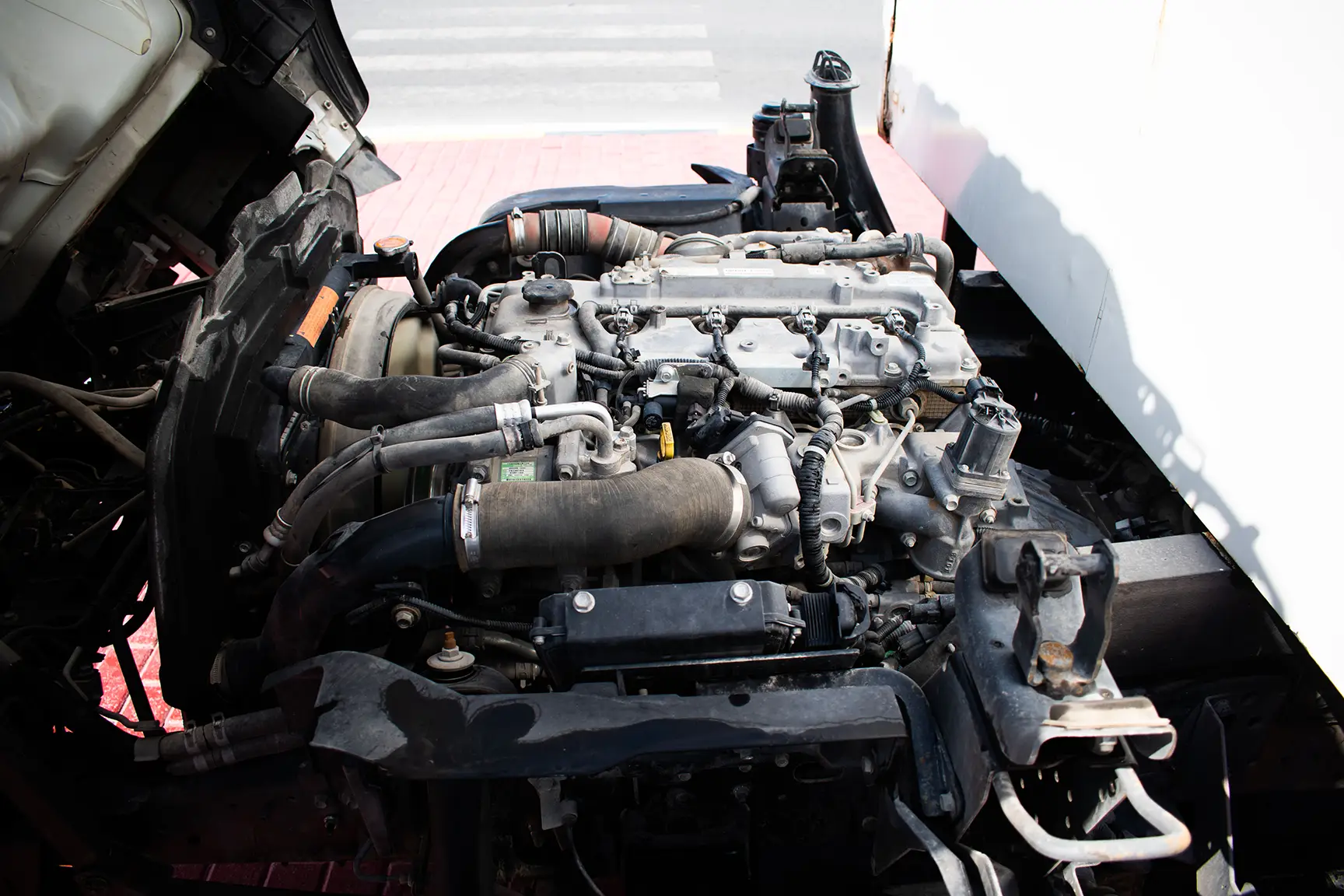 Used 2019 Isuzu NPR Cargo Box in White – Engine Bay View for Sale at First Choice Cars Dubai Sharjah
