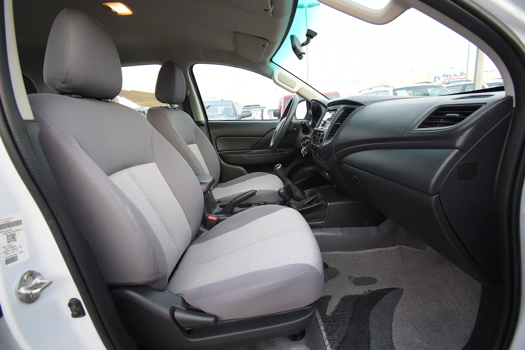 Used 2020 Mitsubishi L200 Double Cab GL White – Front Passenger Side Cabin View at First Choice Cars Sharjah