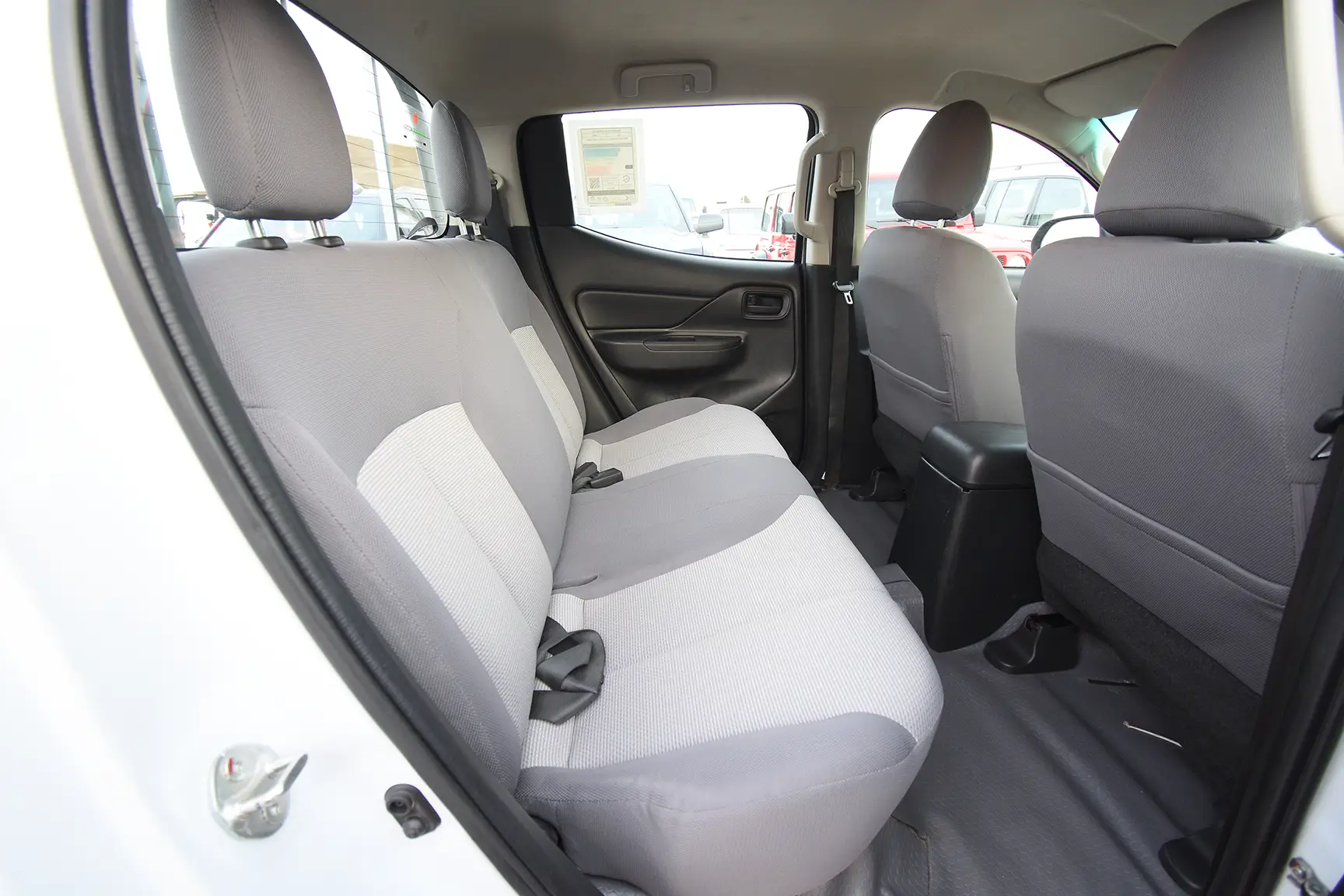 Used 2020 Mitsubishi L200 Double Cab GL White – Rear Passenger Side Cabin View at First Choice Cars Sharjah