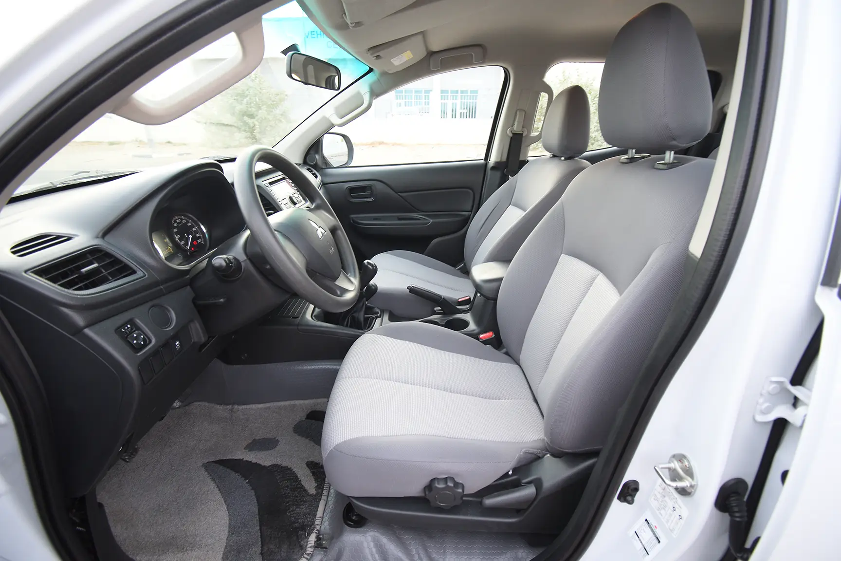 Used 2020 Mitsubishi L200 GL Double Cabin in White – Front Driver Side Cabin View for Sale at First Choice Cars Dubai Sharjah