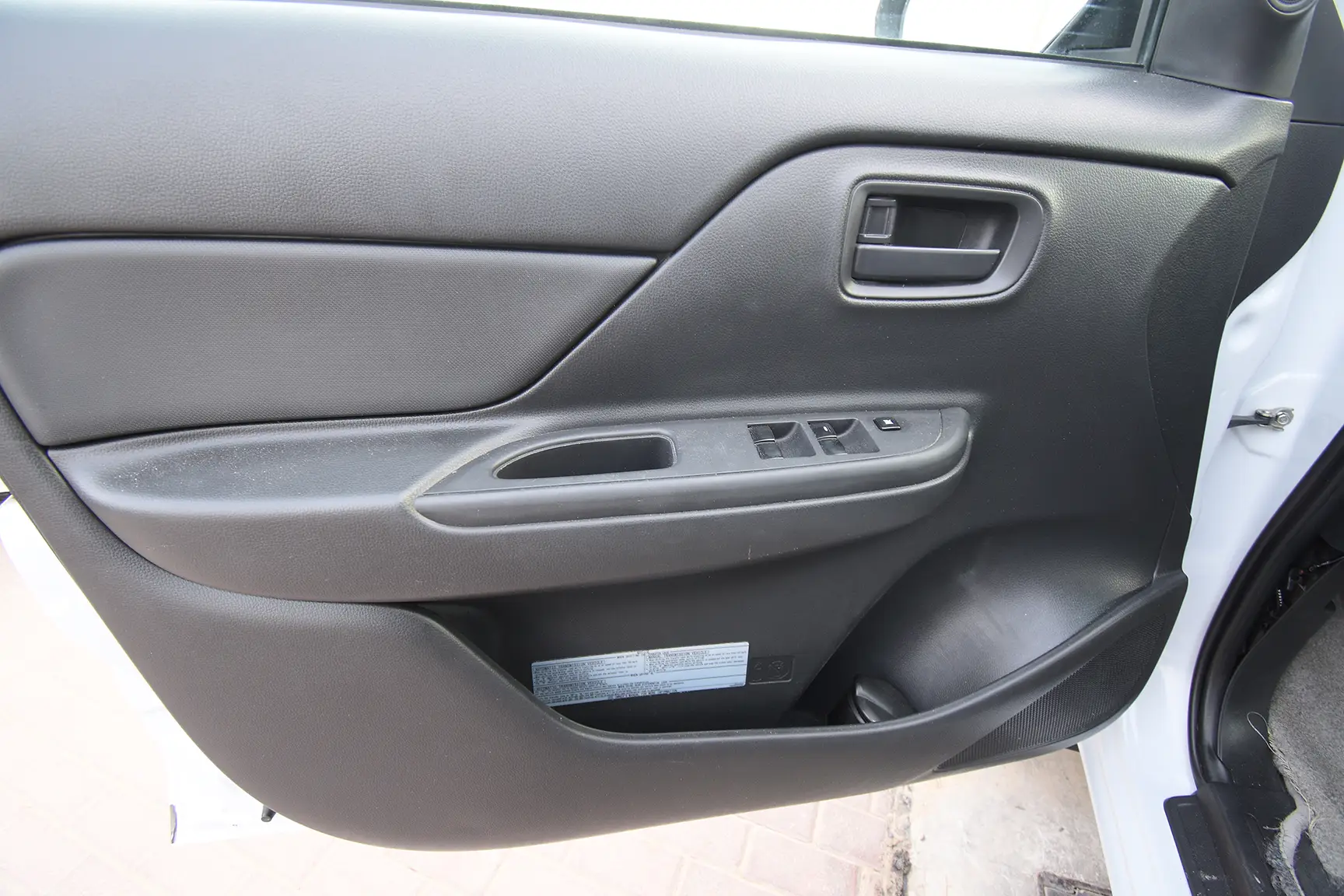Used 2020 Mitsubishi L200 GL Double Cabin in White – Driver Door Panel Full View for Sale at First Choice Cars Dubai Sharjah