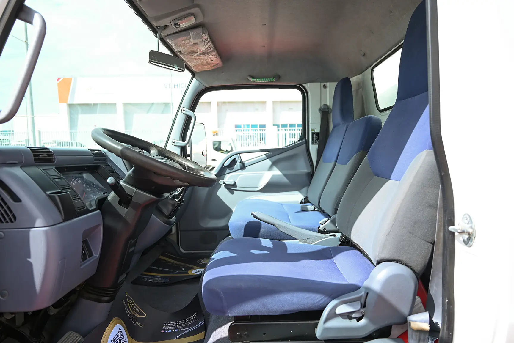 Used 2016 Mitsubishi Canter Cargo Box in White – Front Driver Side Cabin View for Sale at First Choice Cars Dubai Sharjah