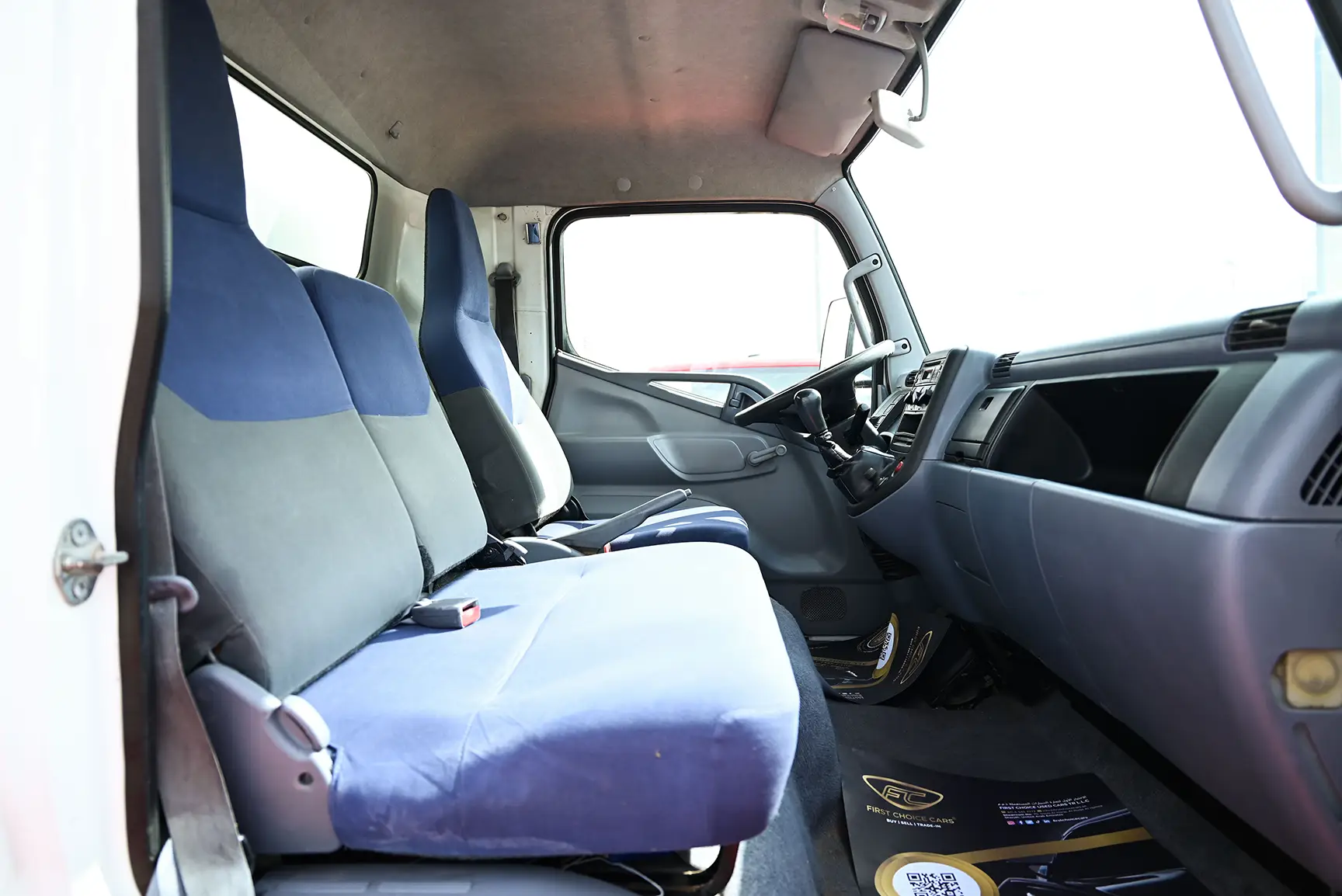 Used 2016 Mitsubishi Canter Cargo Box in White – Front Passenger Side Cabin View for Sale at First Choice Cars Dubai Sharjah