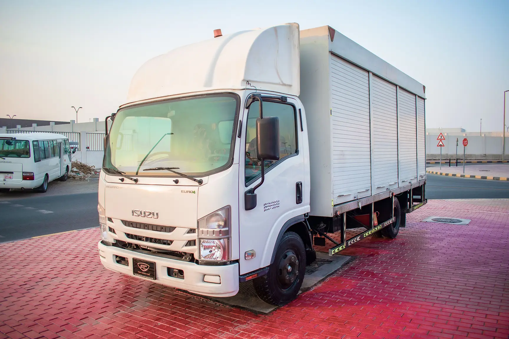 Used 2020 Isuzu NPR Shutter Body White – Left Front Diagonal (45°) View at First Choice Cars Sharjah