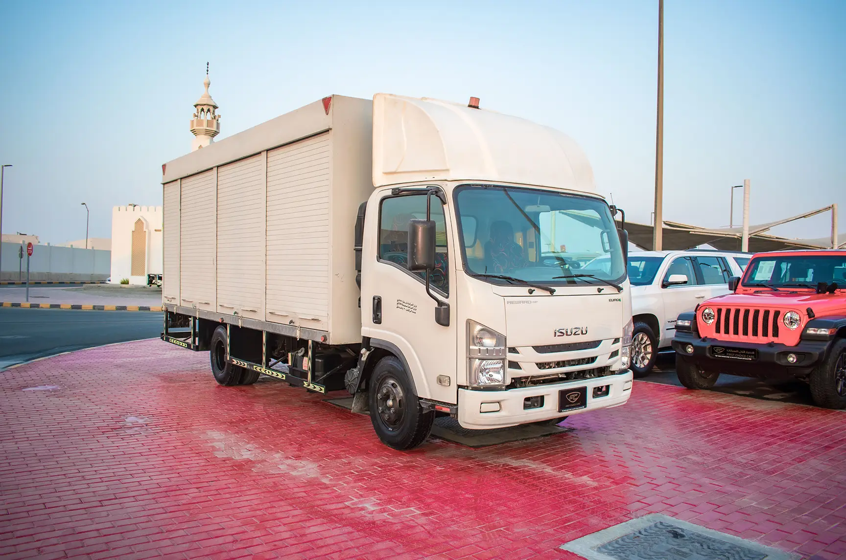 Used 2020 Isuzu NPR Shutter Body White – Right Front Diagonal (45°) View at First Choice Cars Sharjah