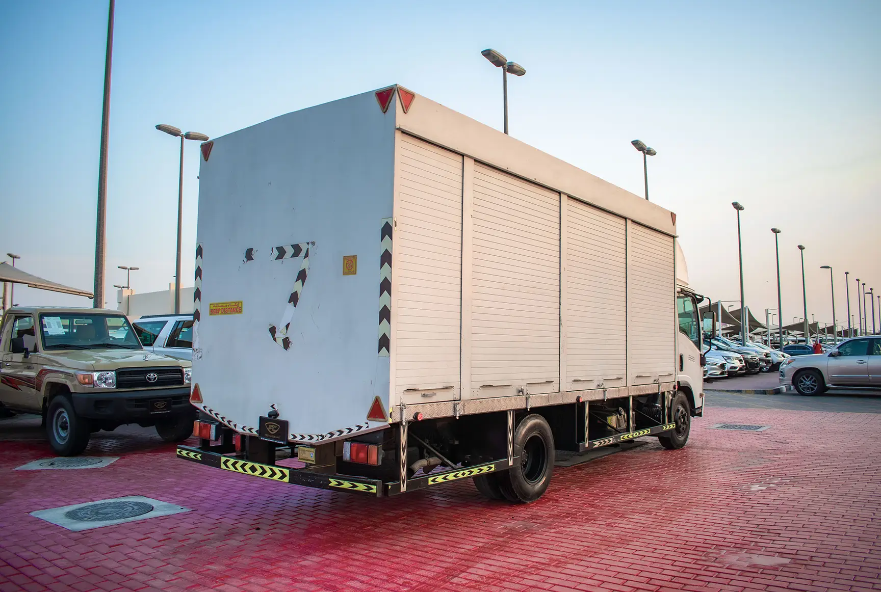 Used 2020 Isuzu NPR Shutter Body White – Right Back Diagonal (45°) View at First Choice Cars Sharjah