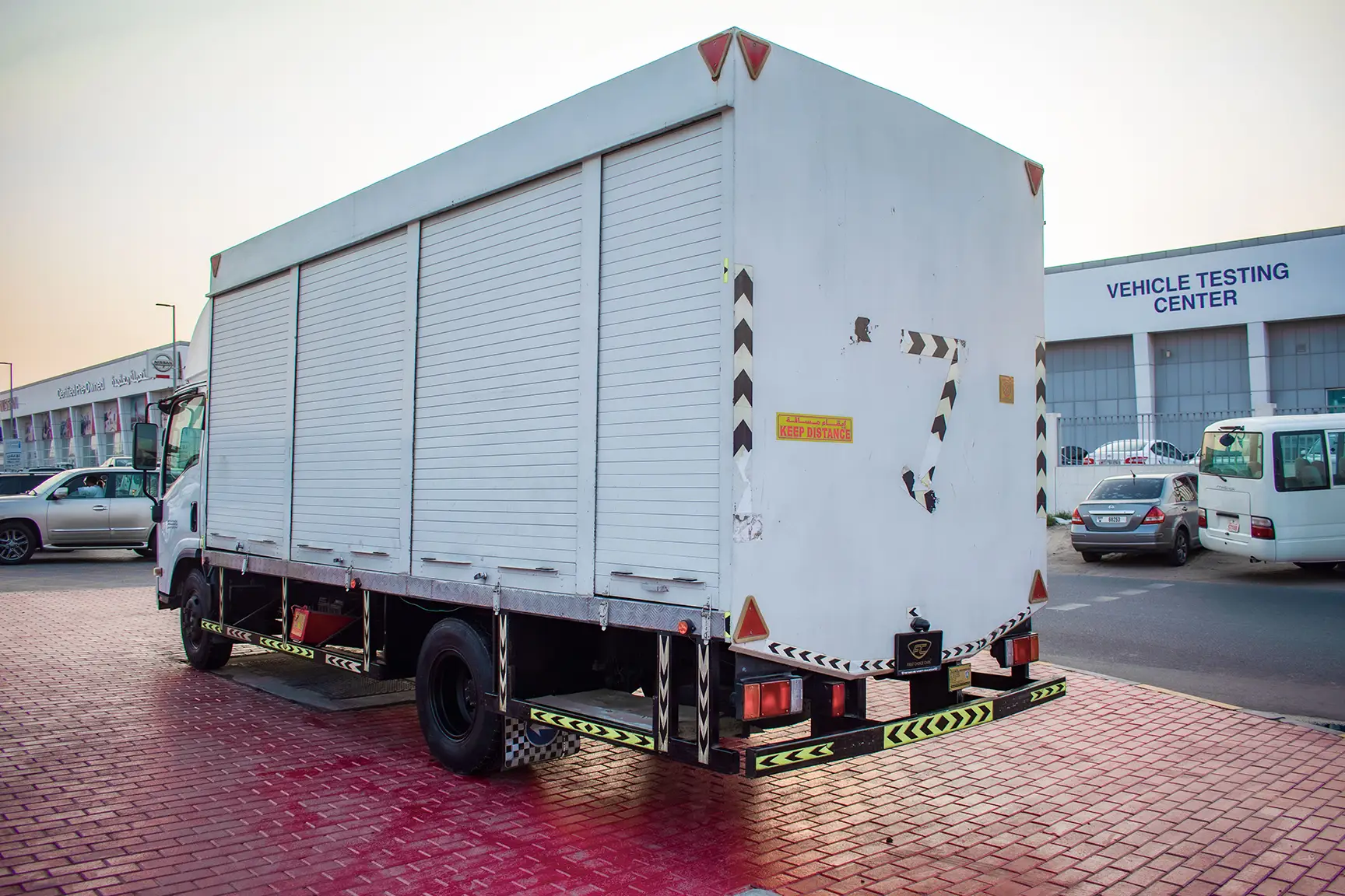 Used 2020 Isuzu NPR Shutter Body White – Left Back Diagonal (45°) View at First Choice Cars Sharjah