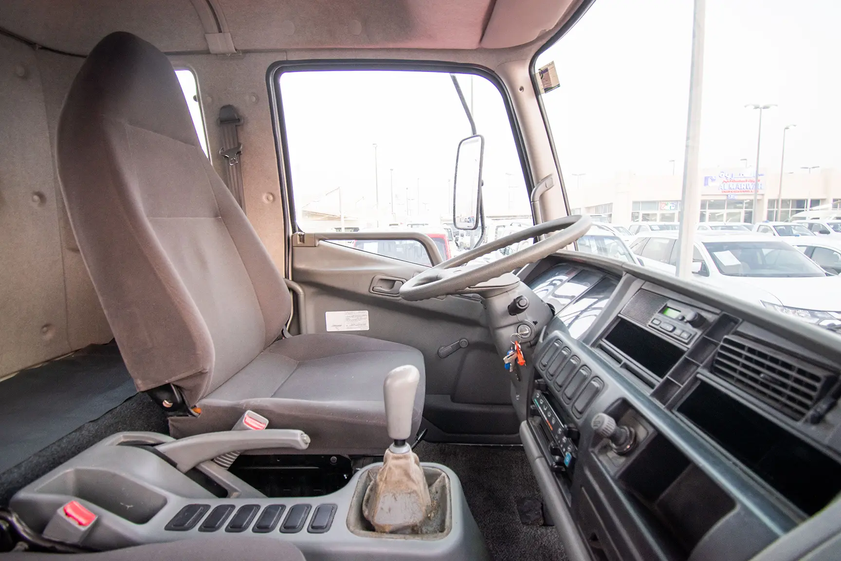 Used 2016 Mitsubishi Canter Cargo Body in White – Front Passenger Side Cabin View for Sale at First Choice Cars Dubai Sharjah