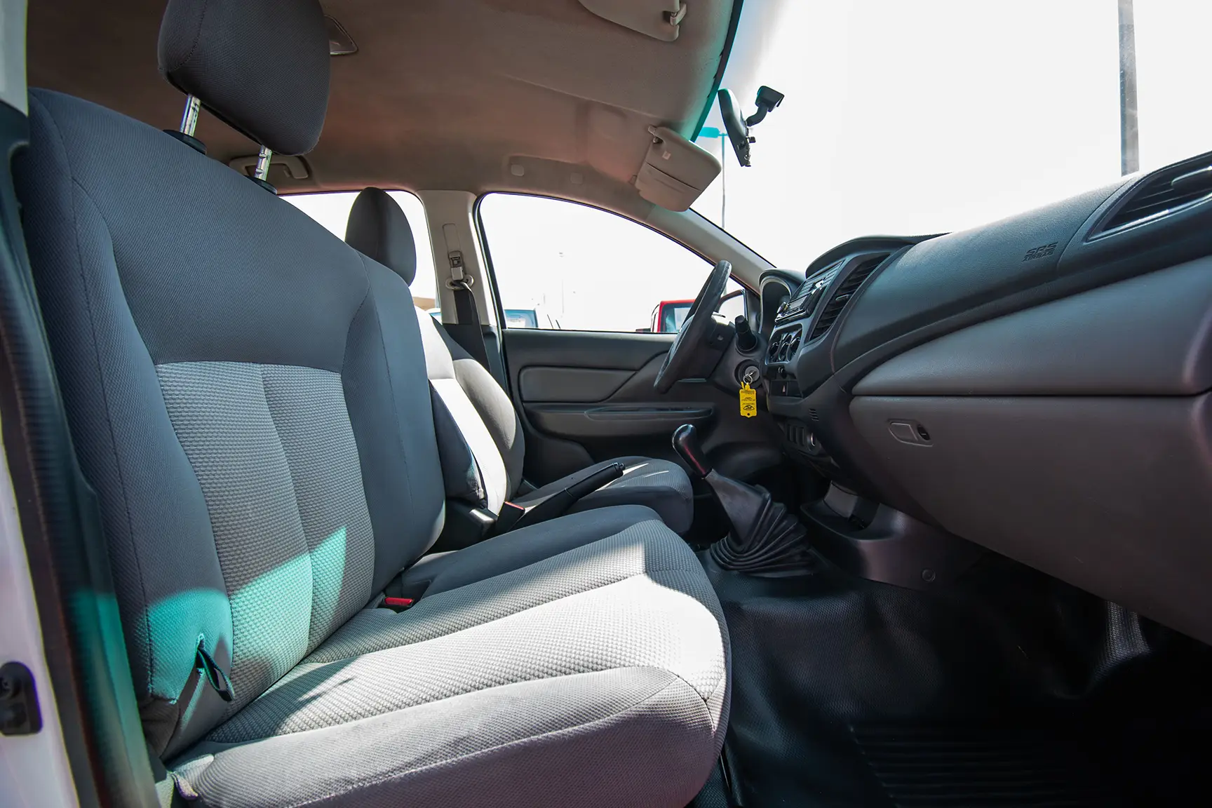 Used 2016 Mitsubishi L200 Double Cab GL White – Front Passenger Side Cabin View at First Choice Cars Sharjah