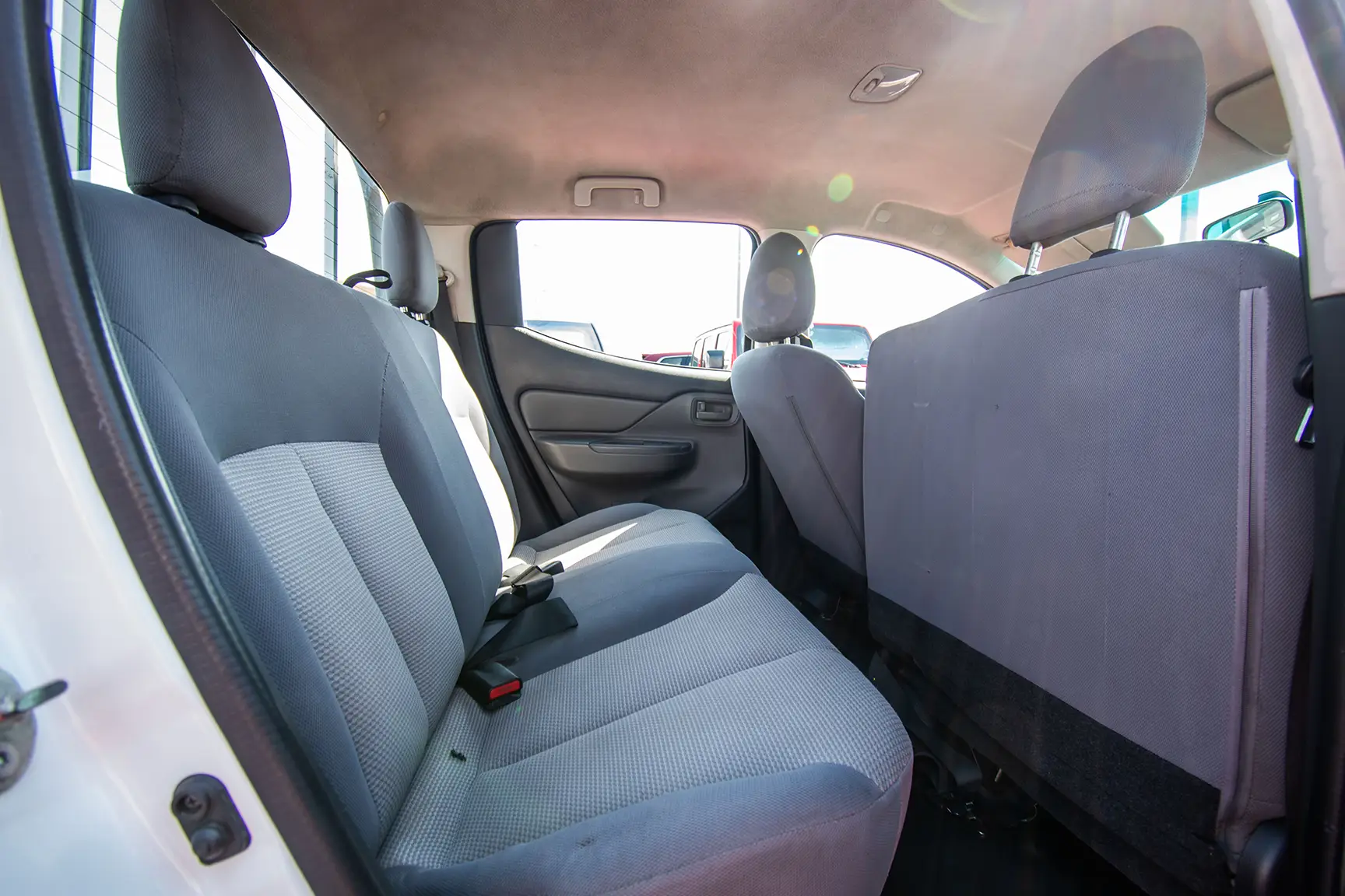 Used 2016 Mitsubishi L200 Double Cab GL White – Rear Passenger Side Cabin View at First Choice Cars Sharjah