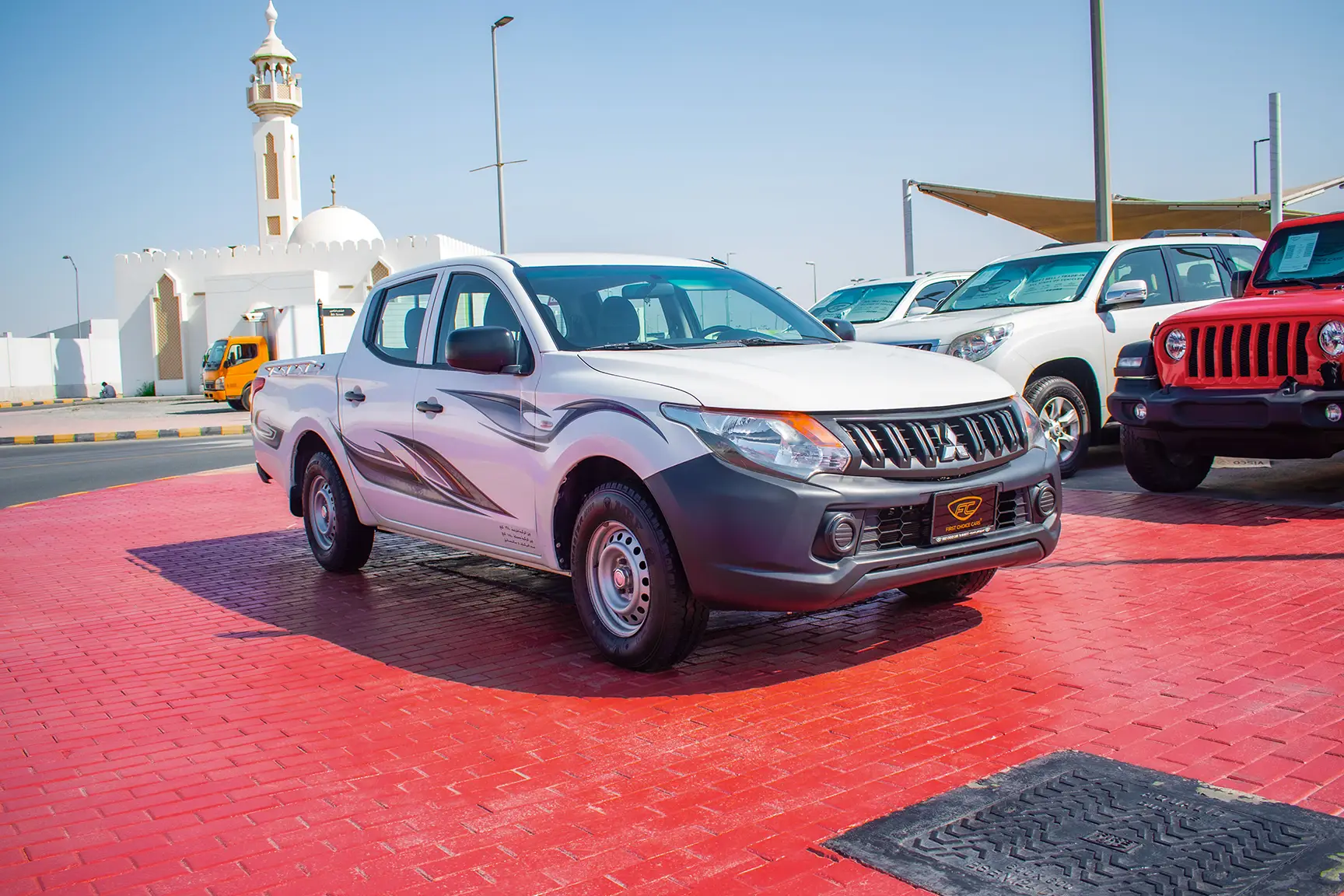 Used 2016 Mitsubishi L200 GL Double Cabin in White – Right Front Diagonal (45°) View for Sale at First Choice Cars Dubai Sharjah
