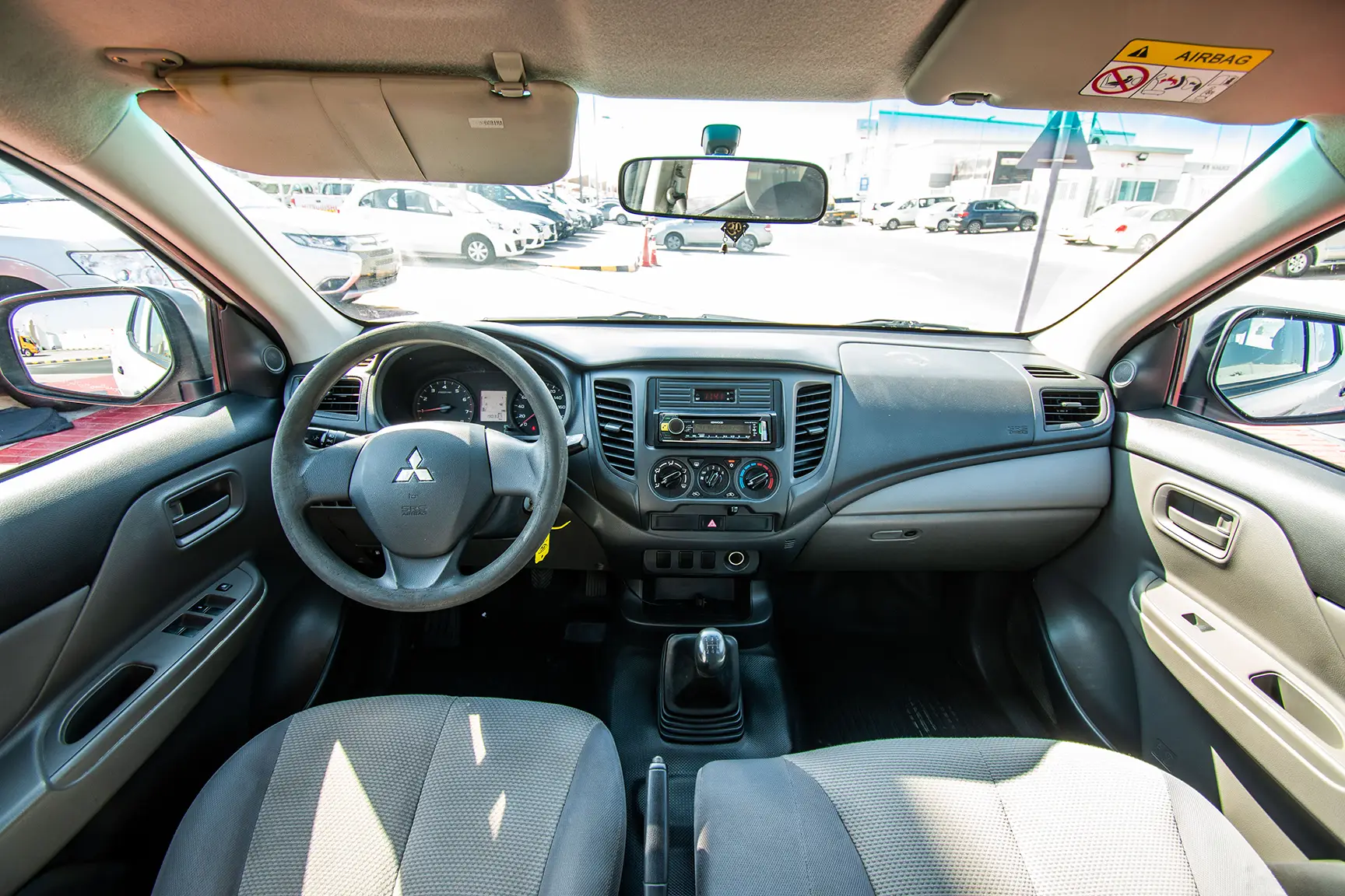 Used 2016 Mitsubishi L200 GL Double Cabin in White – Front Cabin / Dashboard Full View for Sale at First Choice Cars Dubai Sharjah