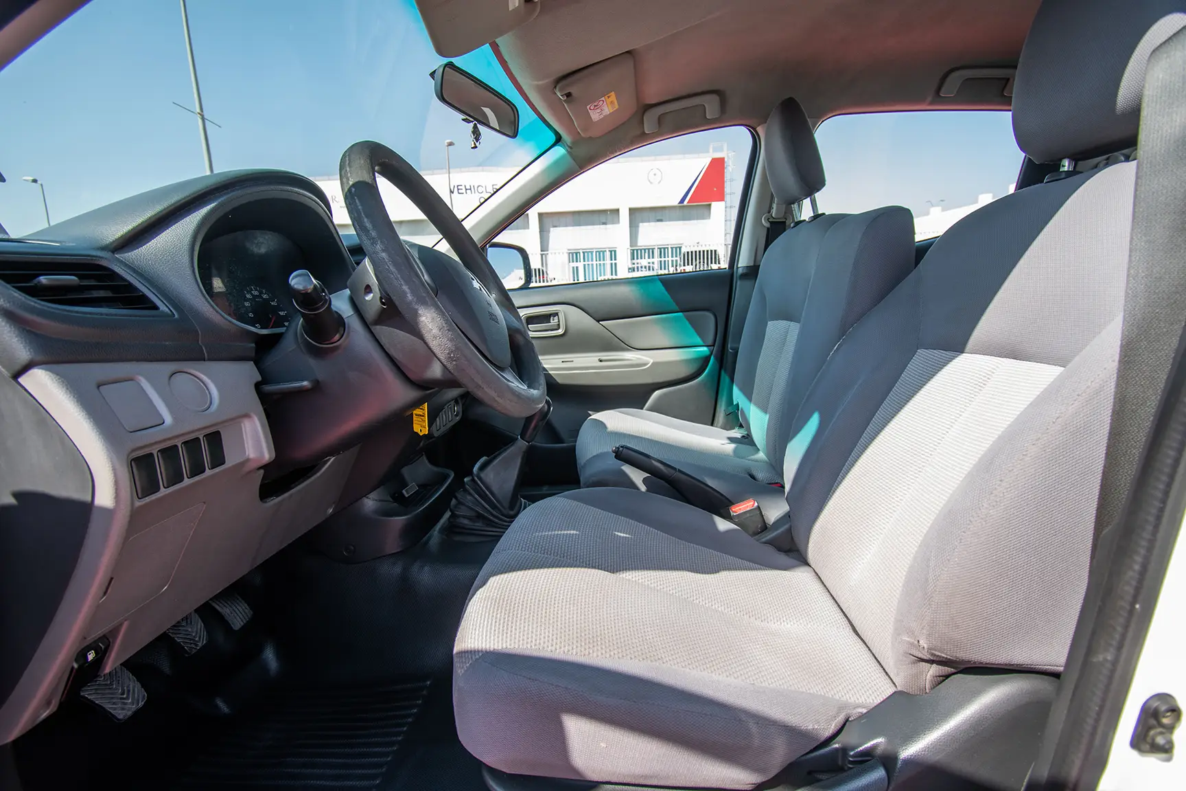 Used 2016 Mitsubishi L200 GL Double Cabin in White – Front Driver Side Cabin View for Sale at First Choice Cars Dubai Sharjah