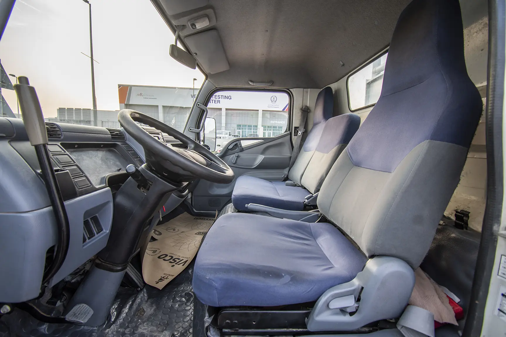 Used 2016 Mitsubishi Canter Tipper in White – Front Driver Side Cabin View for Sale at First Choice Cars Dubai Sharjah