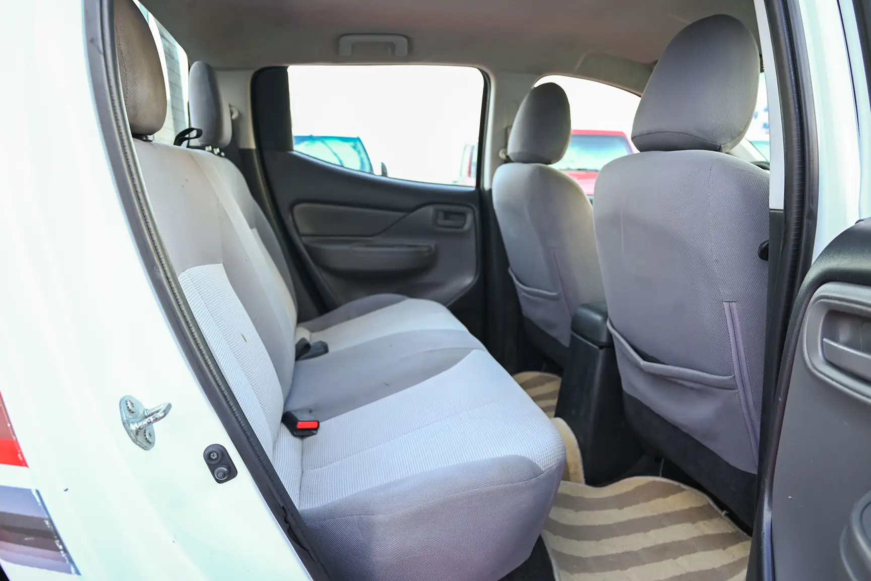 Used 2017 Mitsubishi L200 Double Cab GL White – Rear Passenger Side Cabin View at First Choice Cars Sharjah