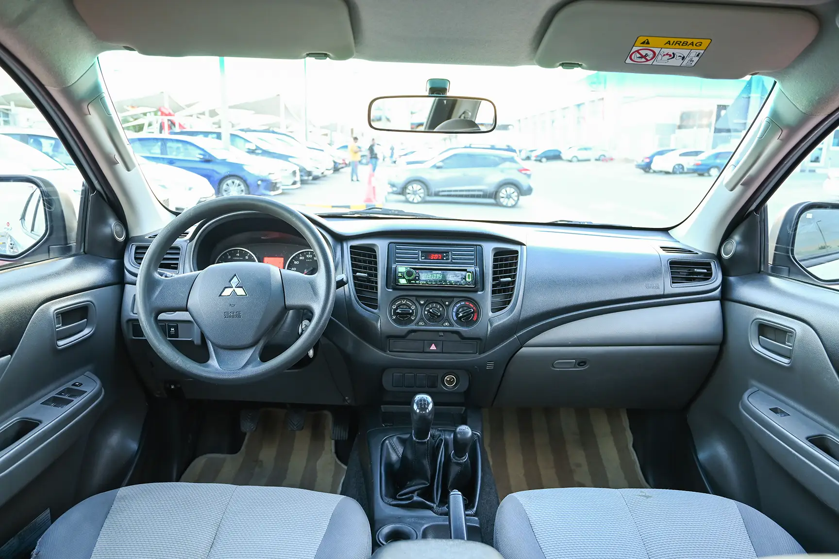 Used 2017 Mitsubishi L200 GL Double Cabin in White – Front Cabin / Dashboard Full View for Sale at First Choice Cars Dubai Sharjah
