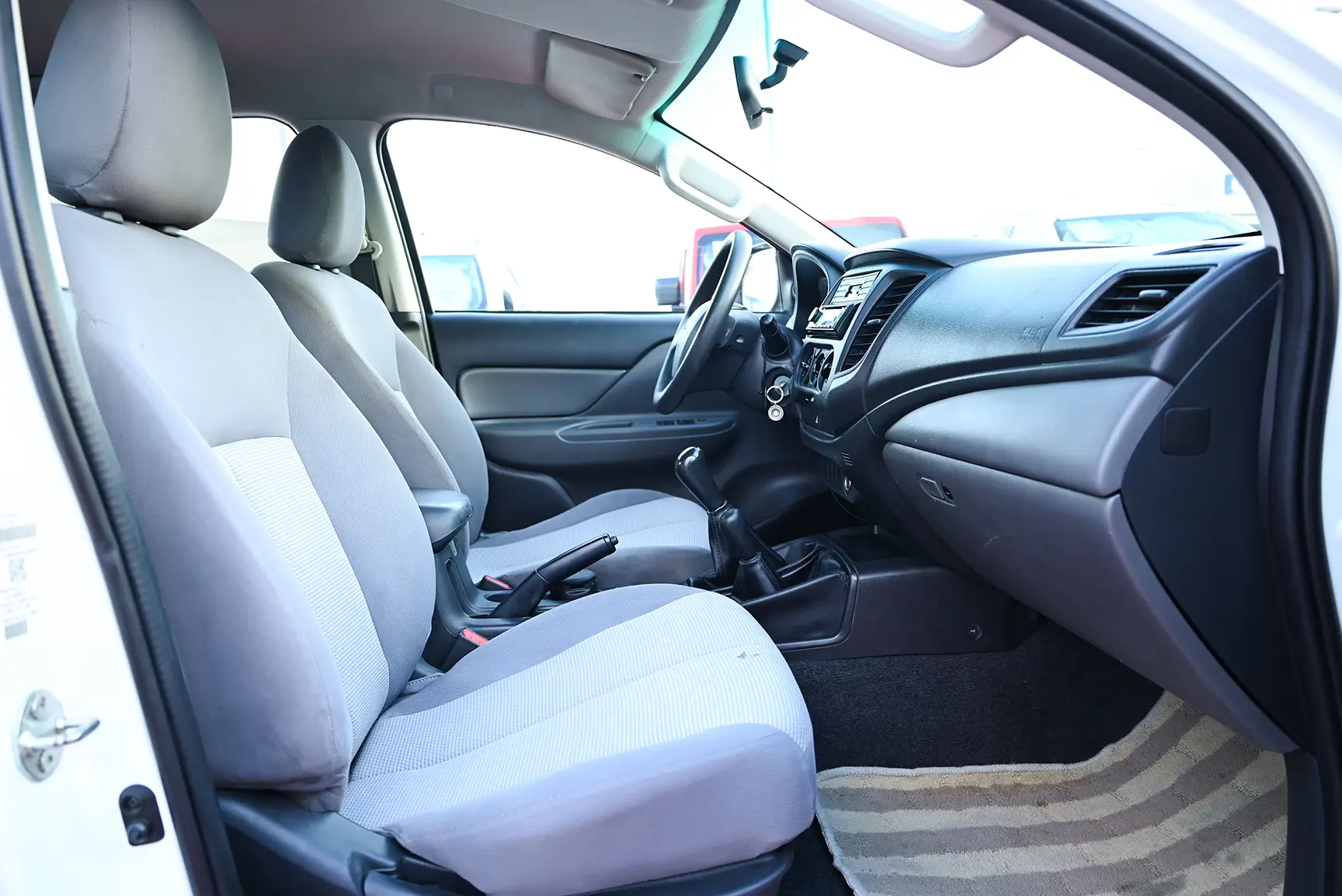 Used 2017 Mitsubishi L200 GL Double Cabin in White – Front Passenger Side Cabin View for Sale at First Choice Cars Dubai Sharjah