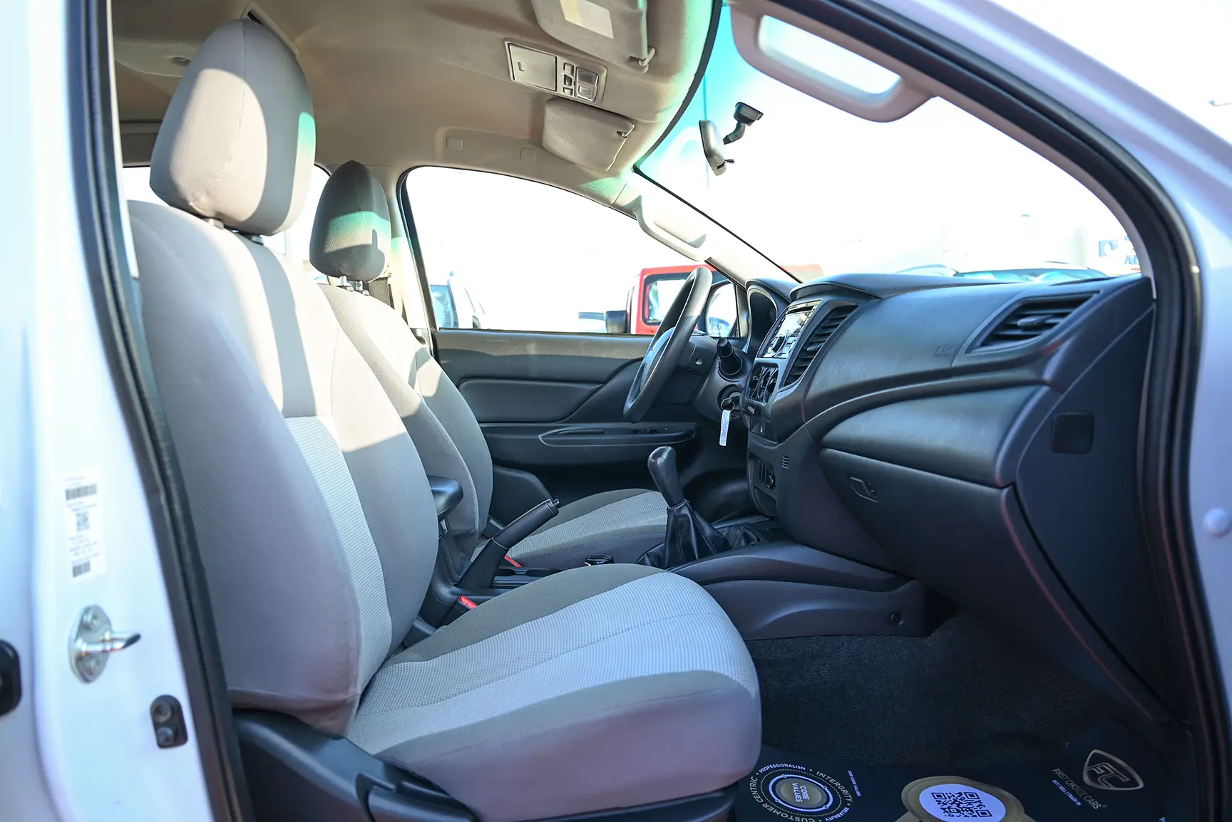 Used 2020 Mitsubishi L200 Double Cab GL White – Front Passenger Side Cabin View at First Choice Cars Sharjah