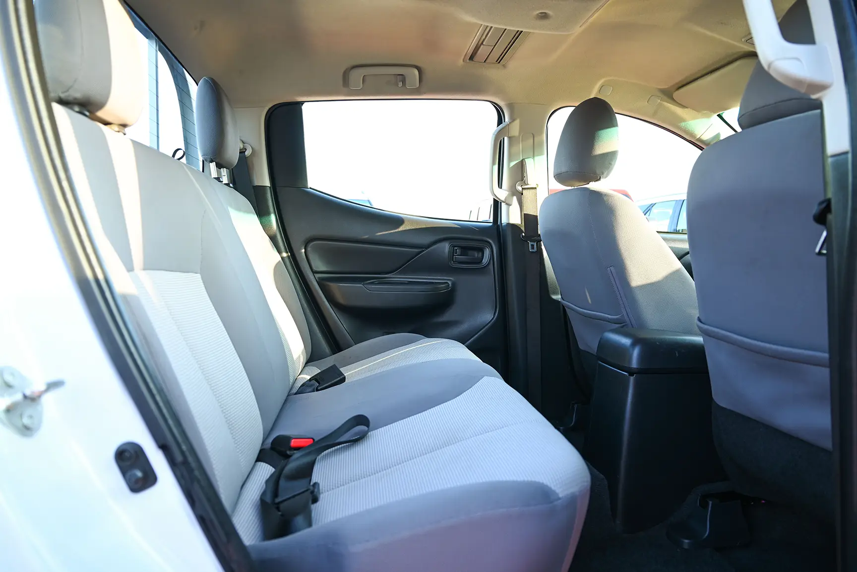 Used 2020 Mitsubishi L200 Double Cab GL White – Rear Passenger Side Cabin View at First Choice Cars Sharjah