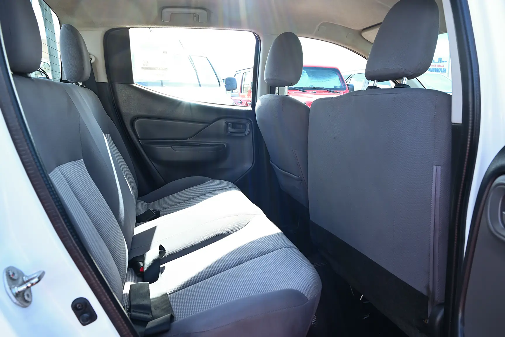 Used 2018 Mitsubishi L200 GL Double Cabin in White – Rear Passenger Side Cabin View for Sale at First Choice Cars Dubai Sharjah