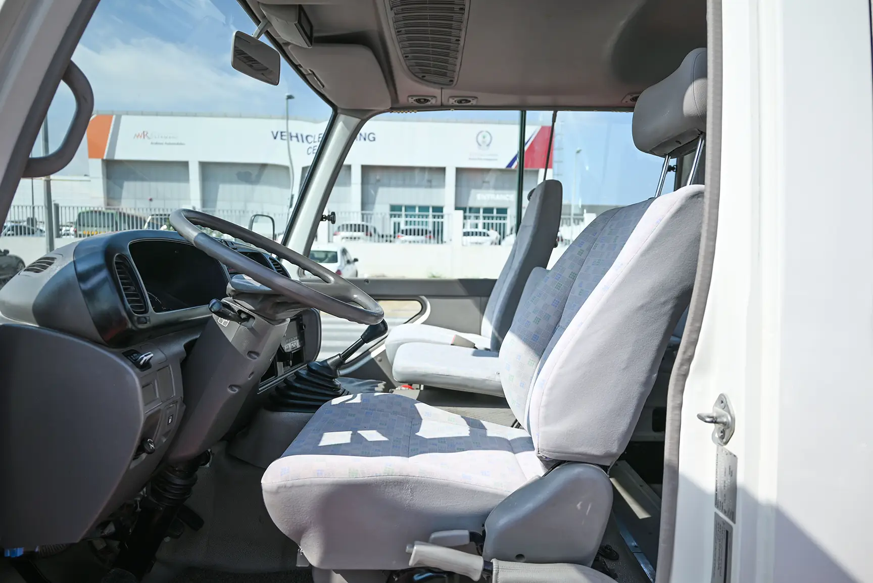 Used 2016 Toyota Coaster Standard Roof in White – Front Driver Side Cabin View