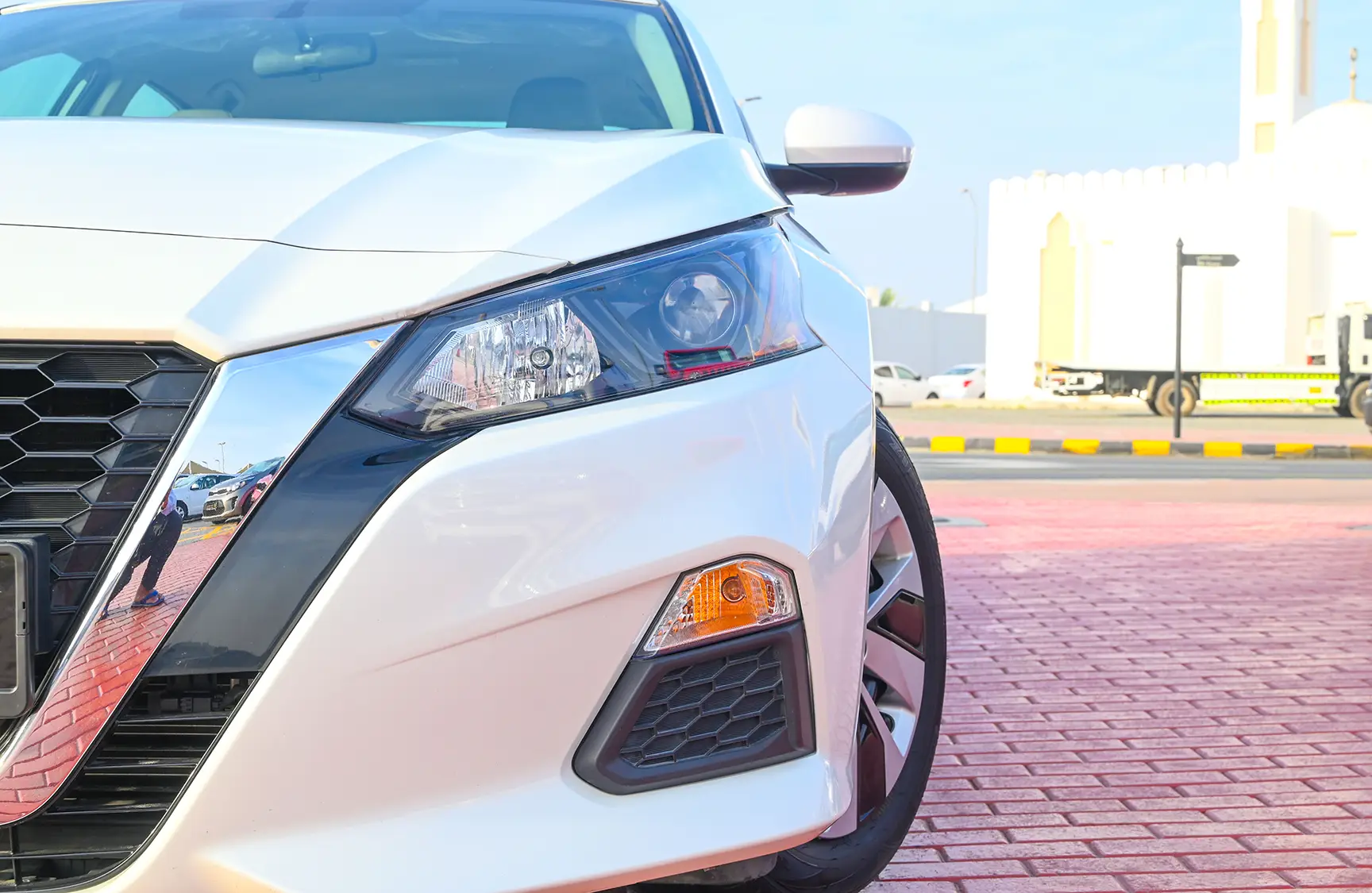 Used 2022 Nissan Altima S White – Headlight Close-up at First Choice Cars Sharjah