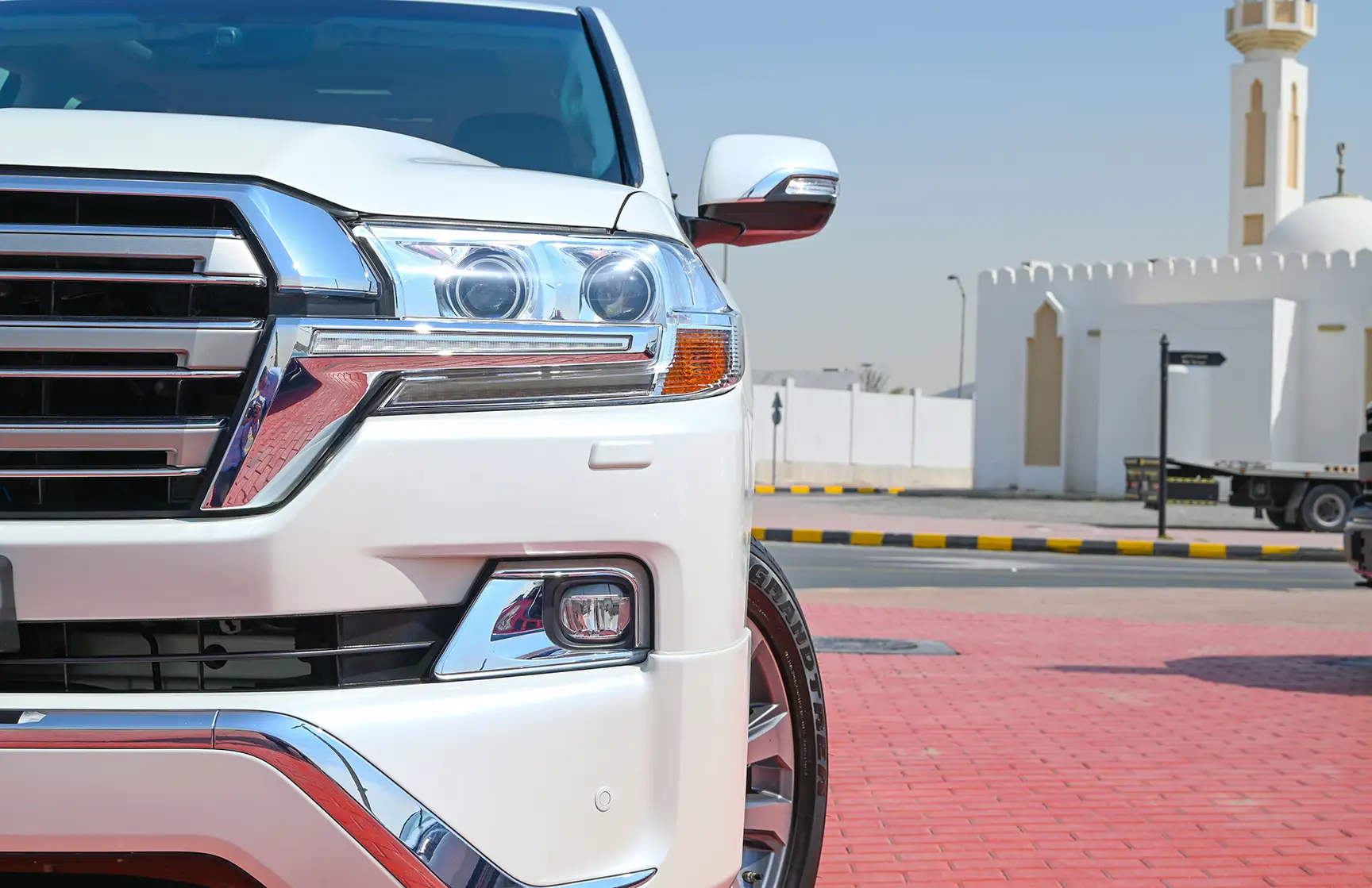 Used 2017 Toyota Land Cruiser VXR White – Headlight Close-up at First Choice Cars Sharjah