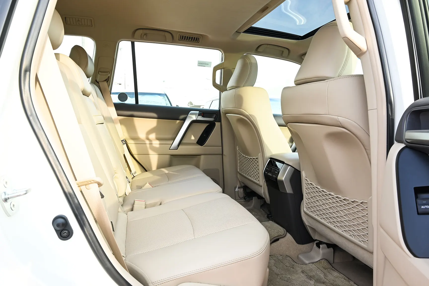 Used 2022 Toyota Prado Adventure White – Rear Passenger Side Cabin View at First Choice Cars Sharjah