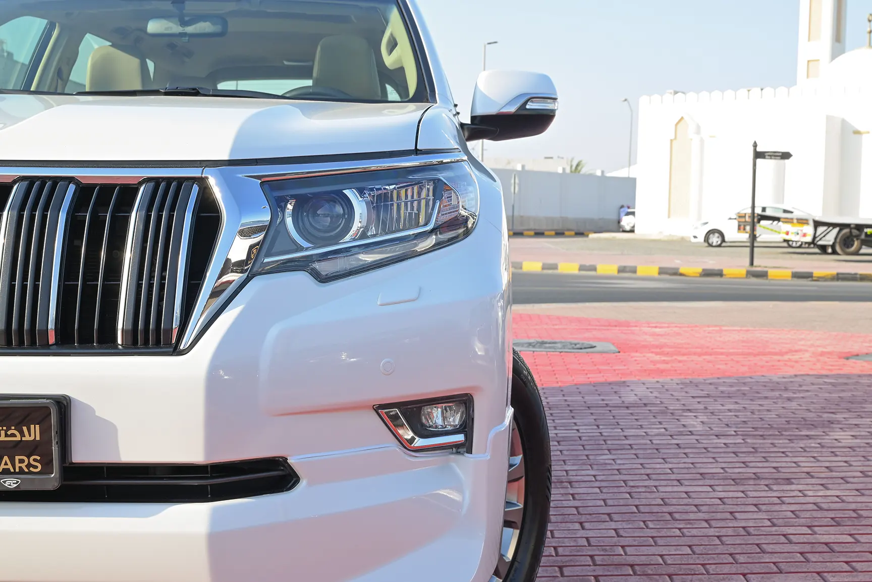 Used 2019 Toyota Prado VXR White – Headlight Close-up at First Choice Cars Sharjah