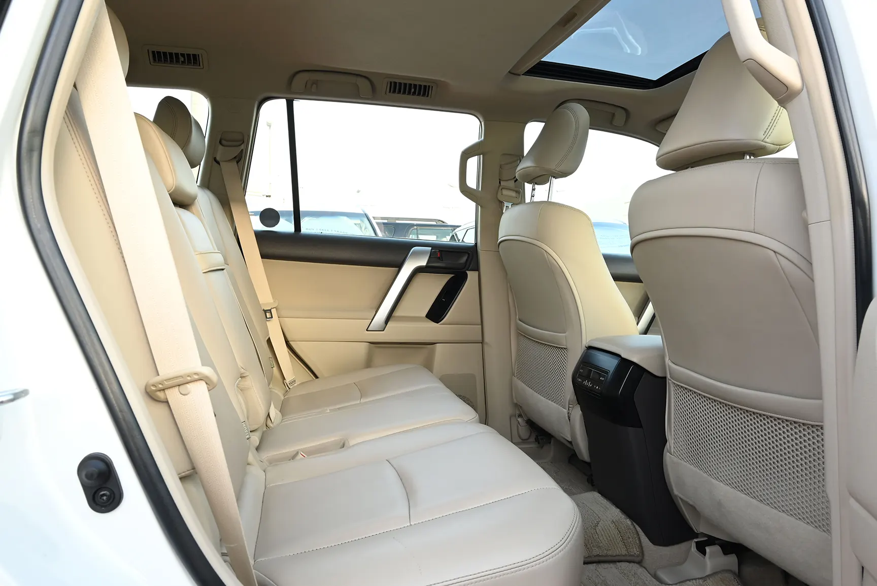 Used 2019 Toyota Prado VXR White – Rear Passenger Side Cabin View at First Choice Cars Sharjah
