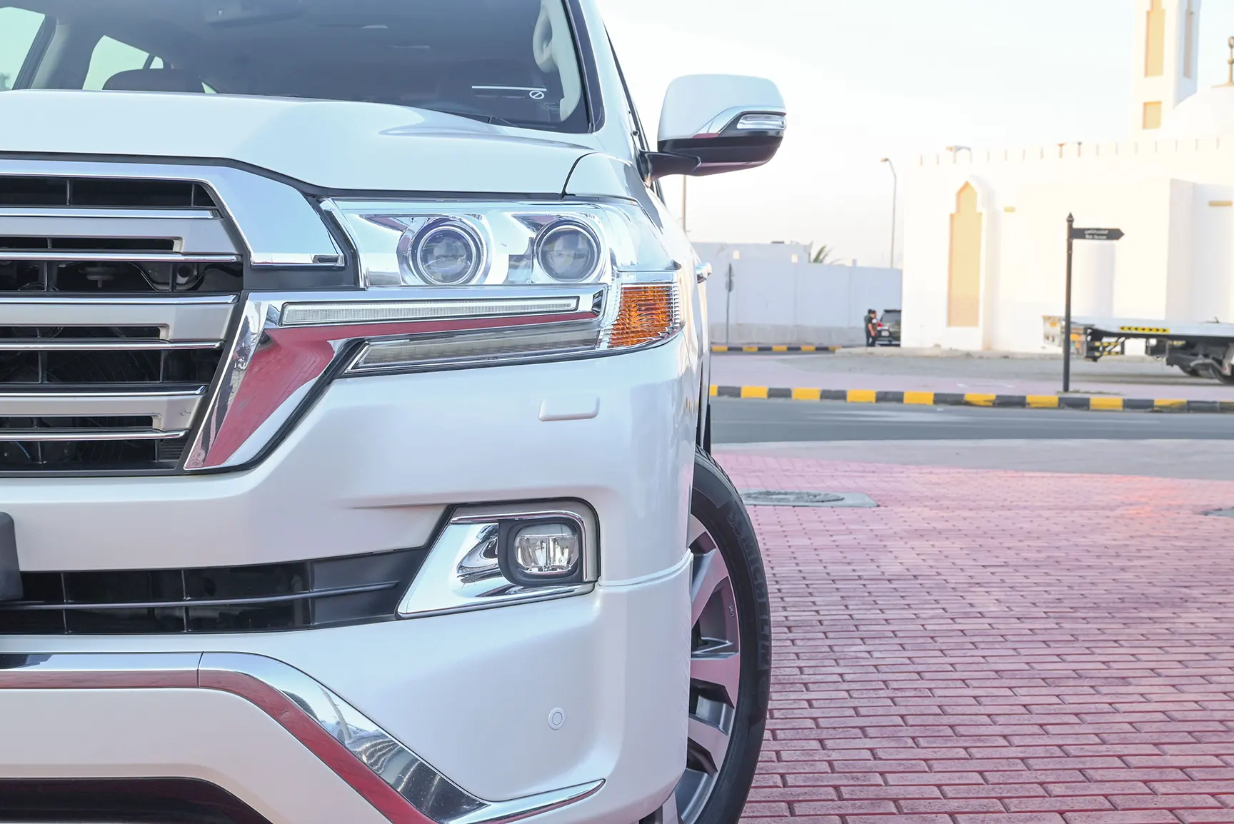 Used 2017 Toyota Land Cruiser VXR White – Headlight Close-up at First Choice Cars Sharjah